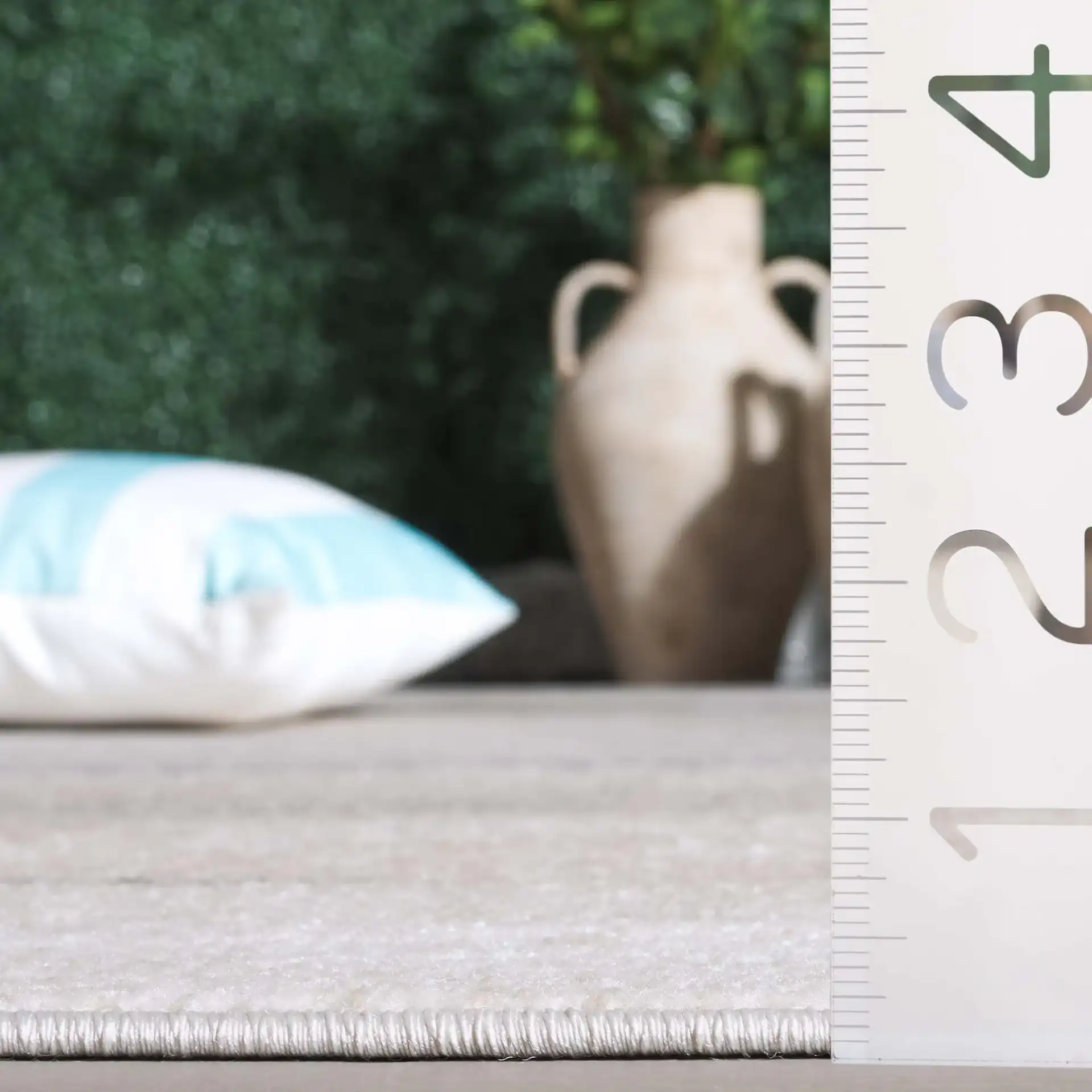 Stella Banded Abstract Outdoor Rug in Beige / Gray in a styled room