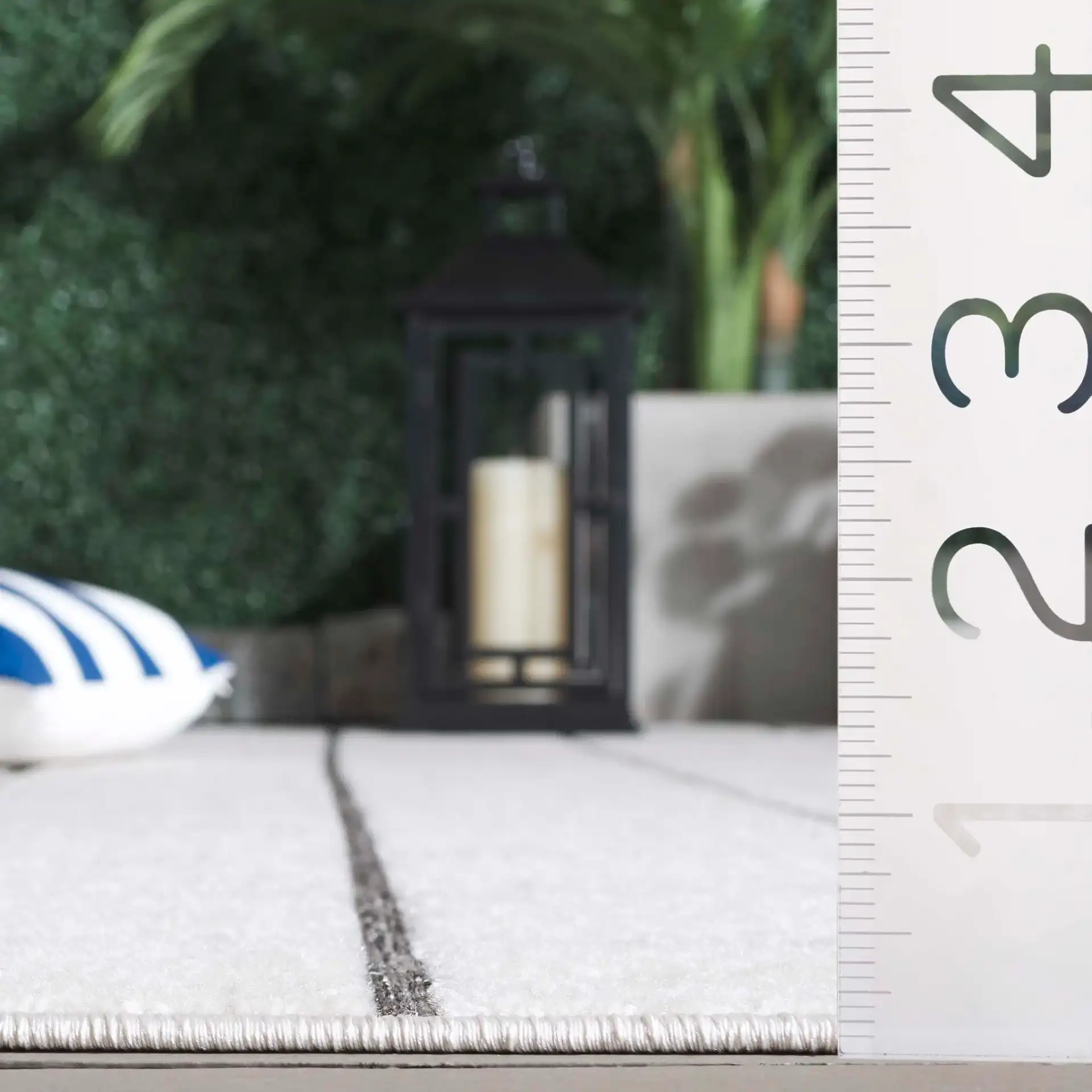 Stella Windowpane Grid Outdoor Rug in Ivory / Gray in a styled room