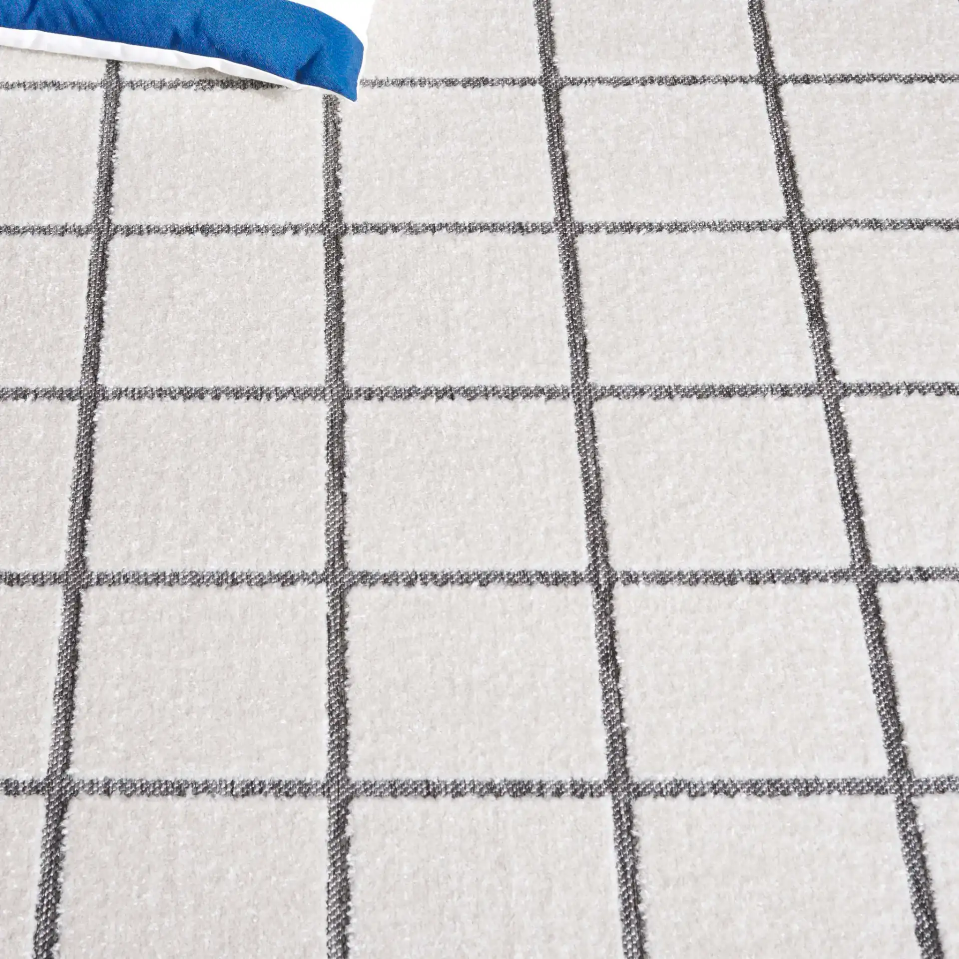 Stella Windowpane Grid Outdoor Rug in Ivory / Gray in a styled room