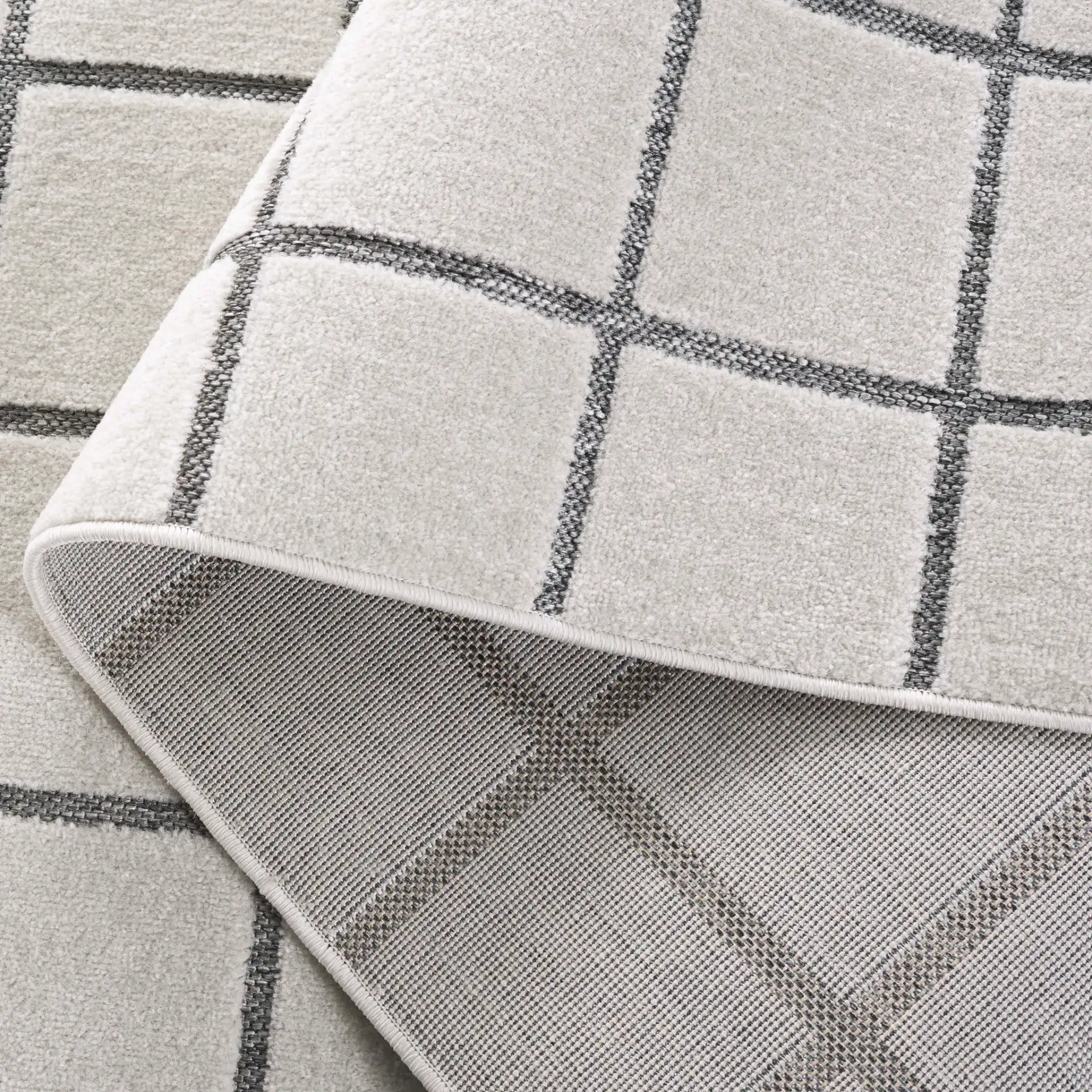 Stella Windowpane Grid Outdoor Rug in Ivory / Gray in a styled room