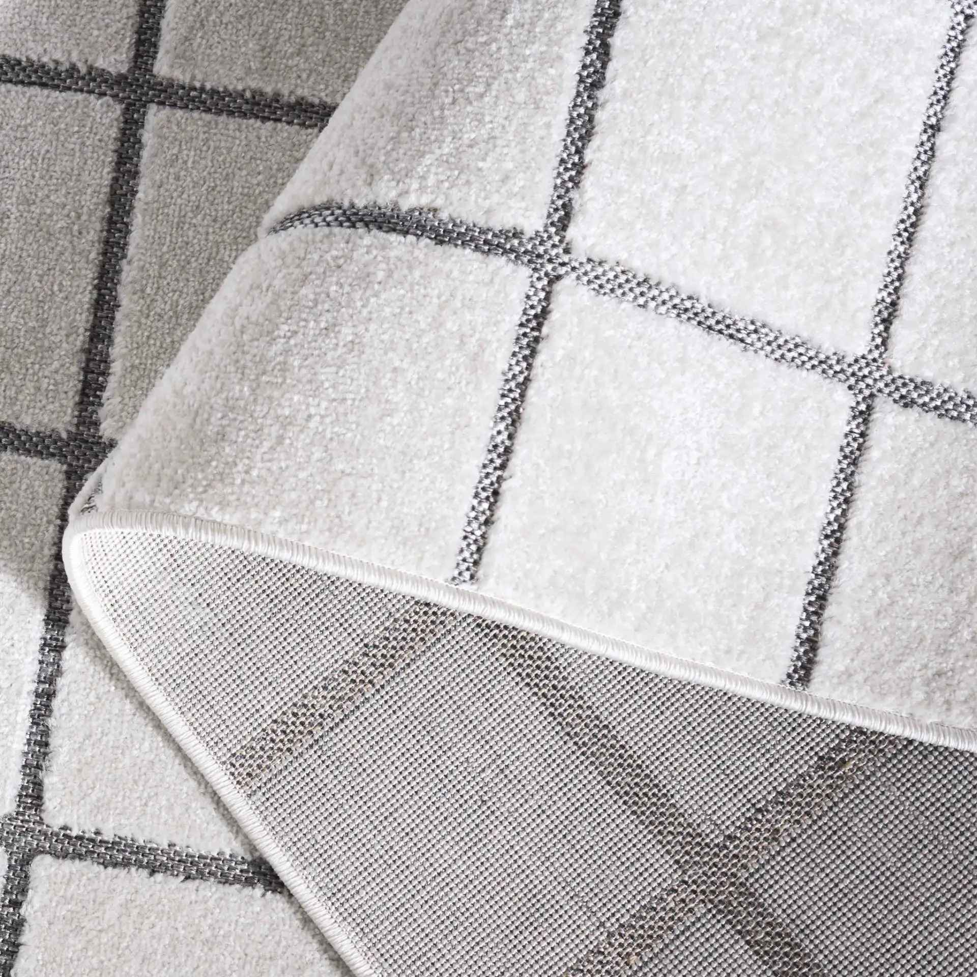 Stella Windowpane Grid Outdoor Rug in Ivory / Gray in a styled room