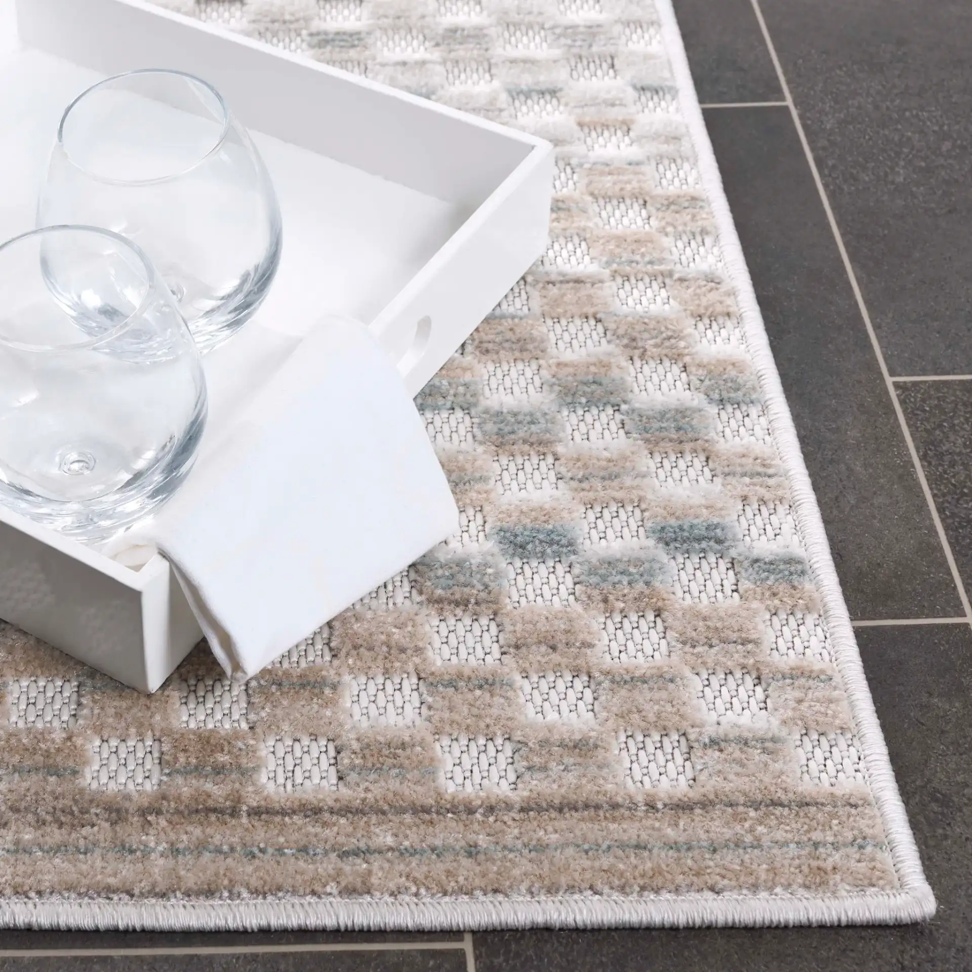 Stella Grid Stripe Outdoor Rug in Beige / Blue in a styled room