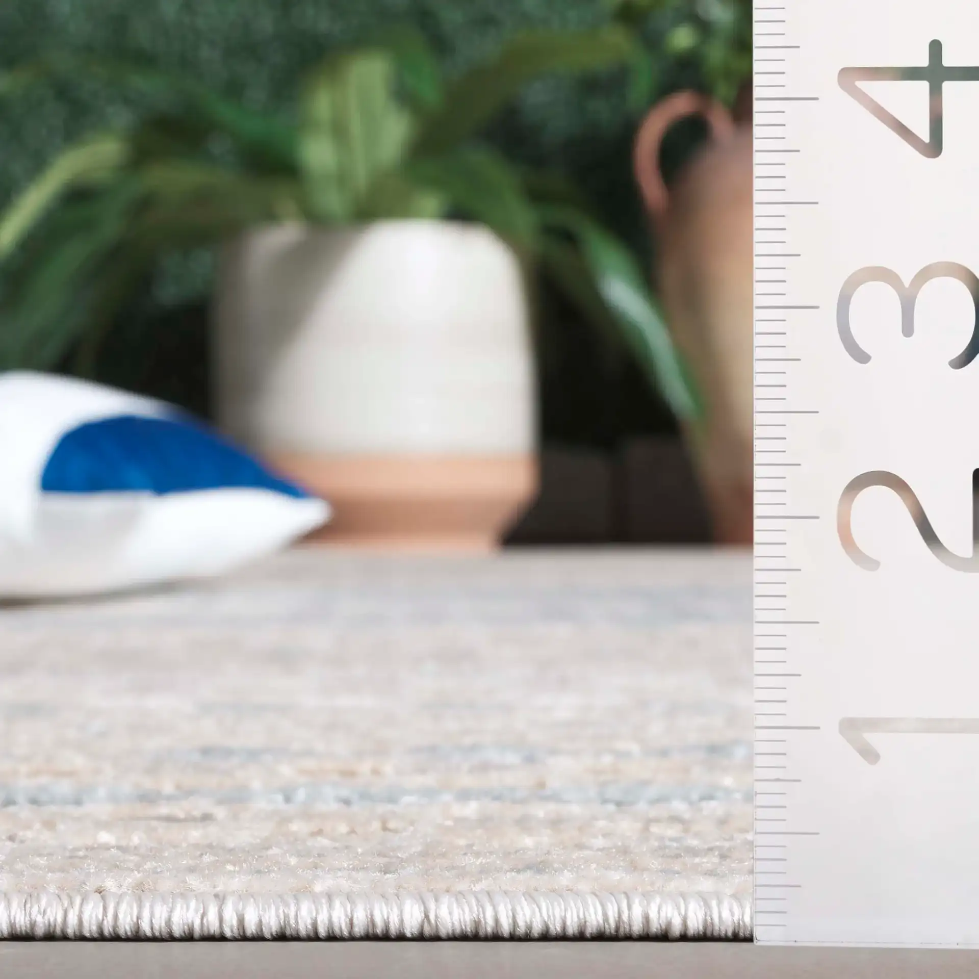 Stella Grid Stripe Outdoor Rug in Beige / Blue in a styled room