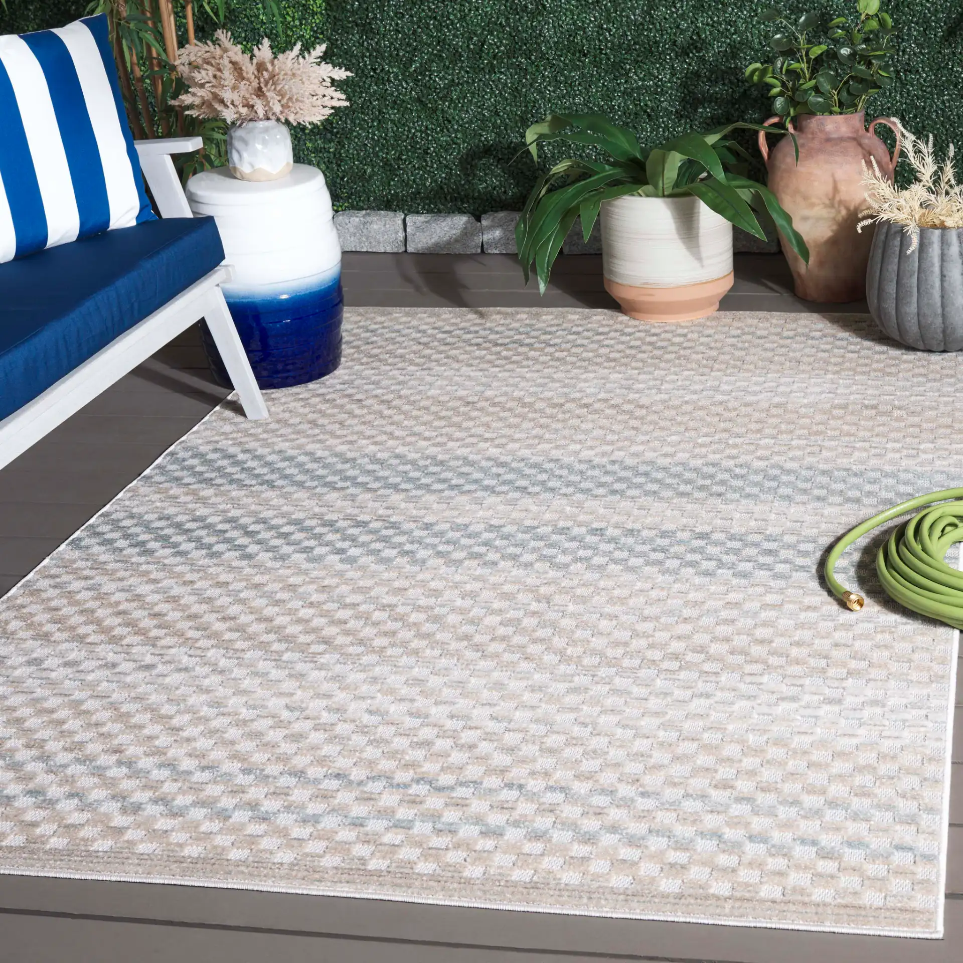 Stella Grid Stripe Outdoor Rug in Beige / Blue in a styled room