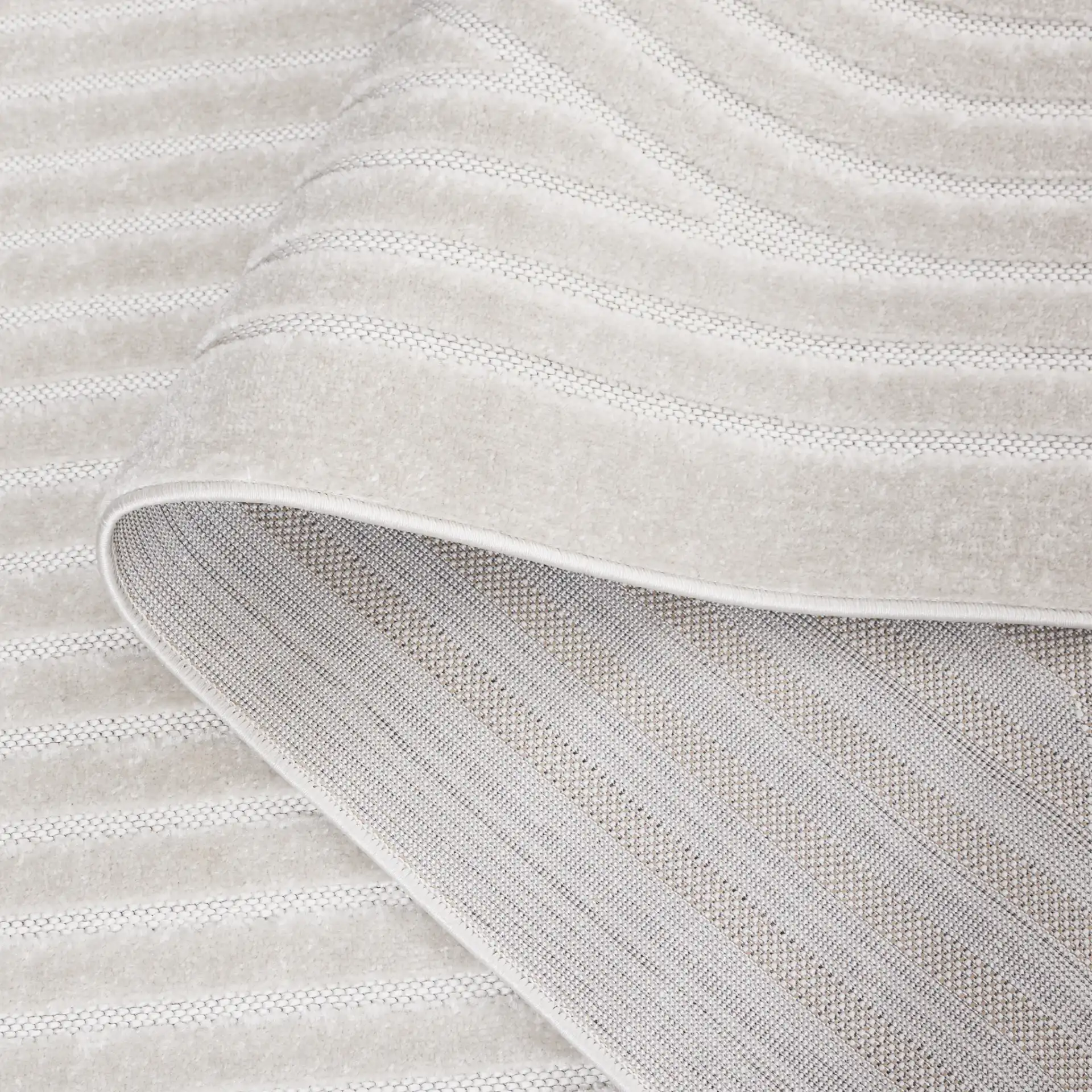 Stella Mirrored Arch Outdoor Rug in Ivory in a styled room