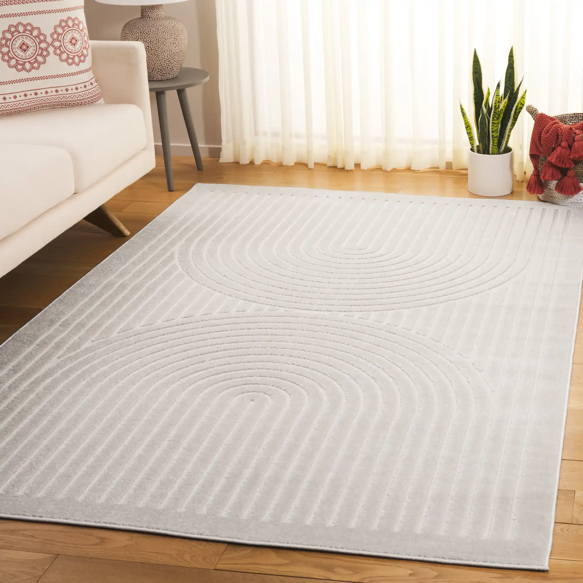 Stella Mirrored Arch Outdoor Rug in Ivory in a styled room