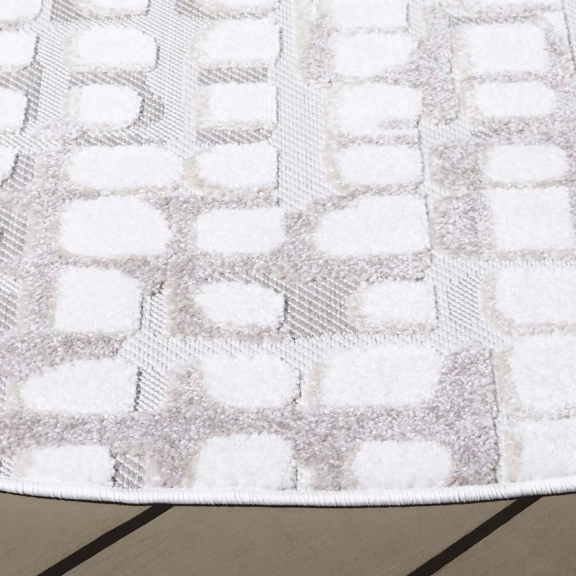 Stella Grid Outdoor Rug in Ivory / Beige in a styled room