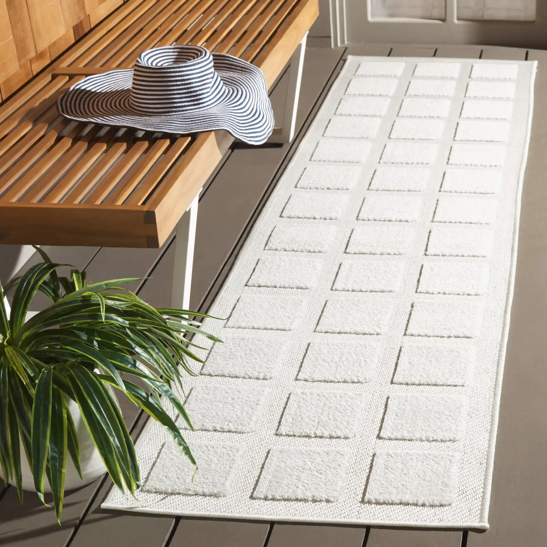 Stella Square Grid Outdoor Rug in Ivory in a styled room