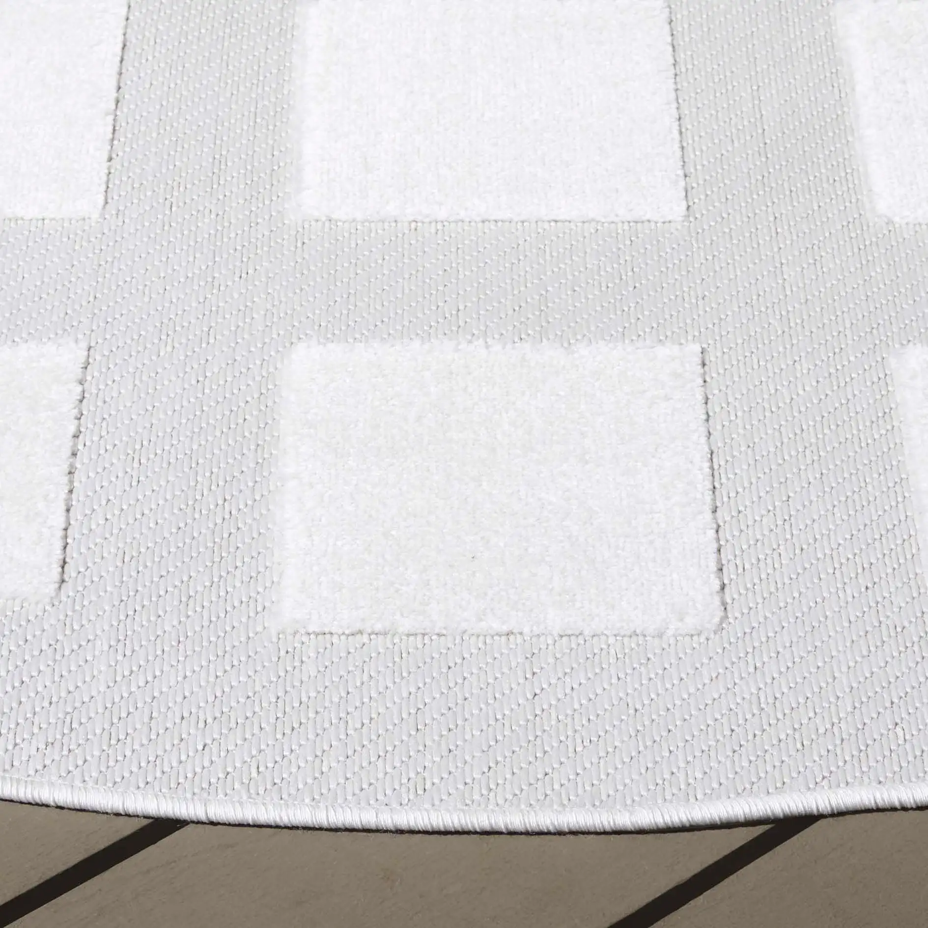 Stella Square Grid Outdoor Rug in Ivory in a styled room