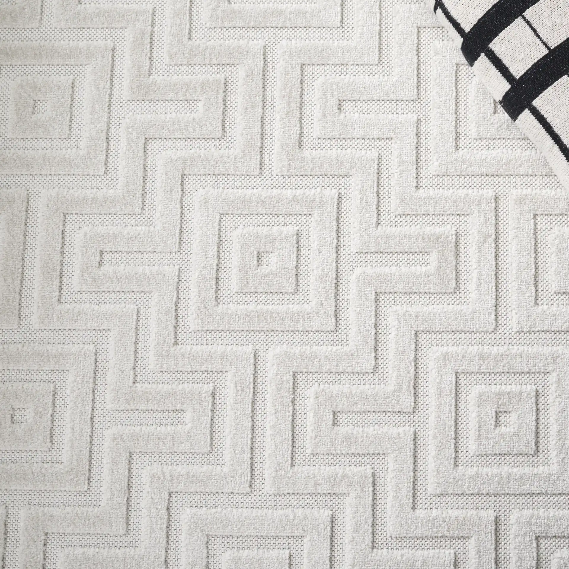 Stella Interlocking Squares Outdoor Rug in Ivory in a styled room