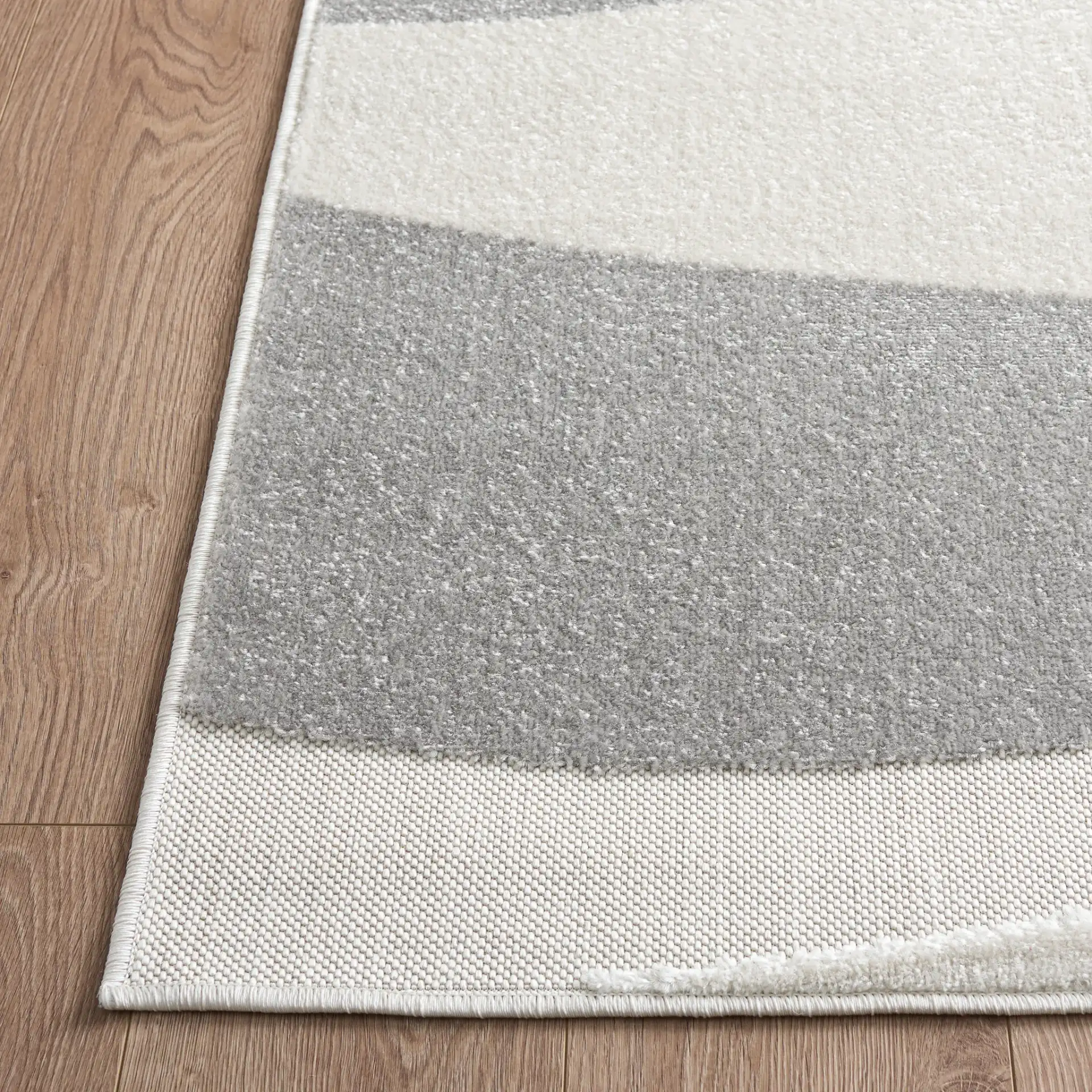 Stella Modern Wave Rug in Ivory / Gray in a styled room