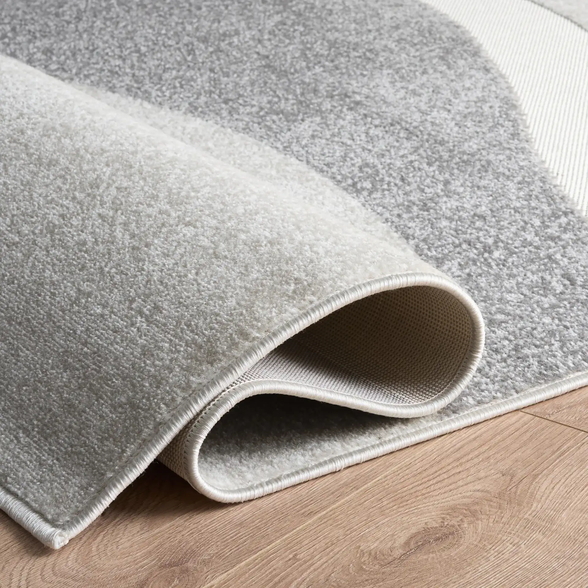Stella Modern Wave Rug in Ivory / Gray in a styled room