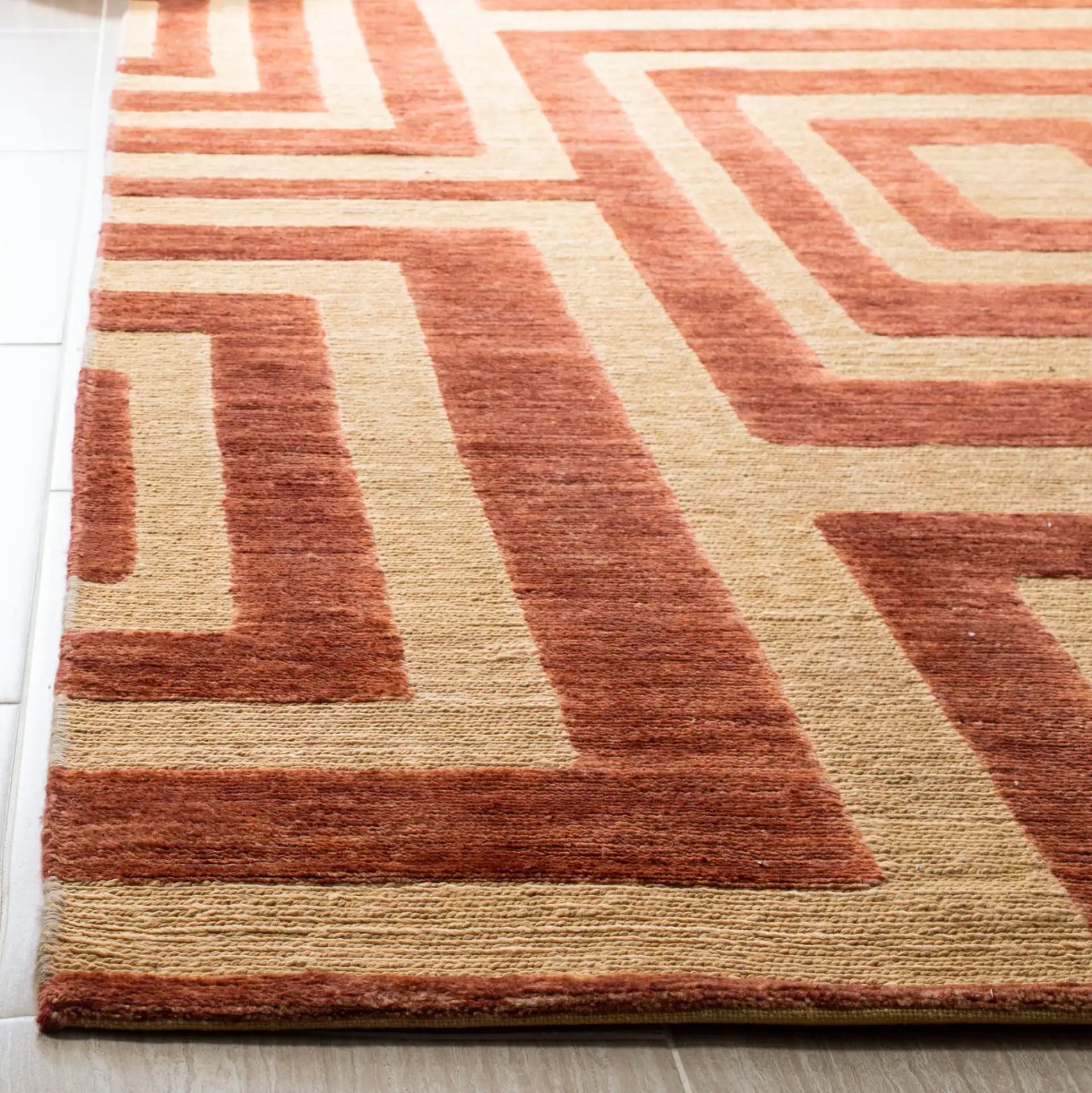 Santa Fe Interlocking Square Hand-Knotted Wool Rug in Light Gold in a styled room