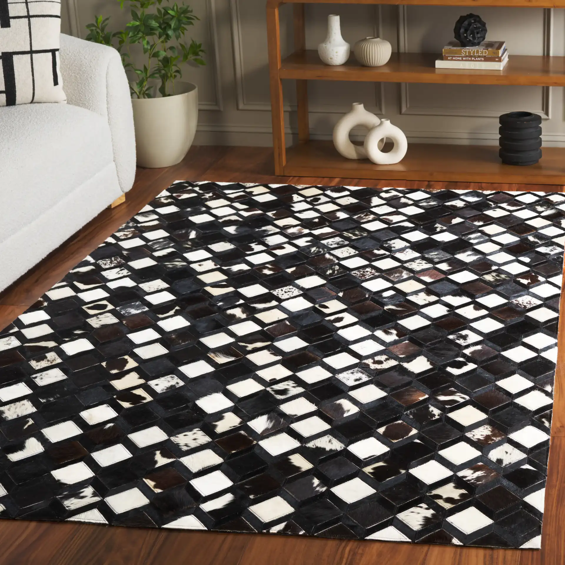 Studio Leather Diamond Patchwork Hand-Woven Rug in Black / Ivory in a styled room