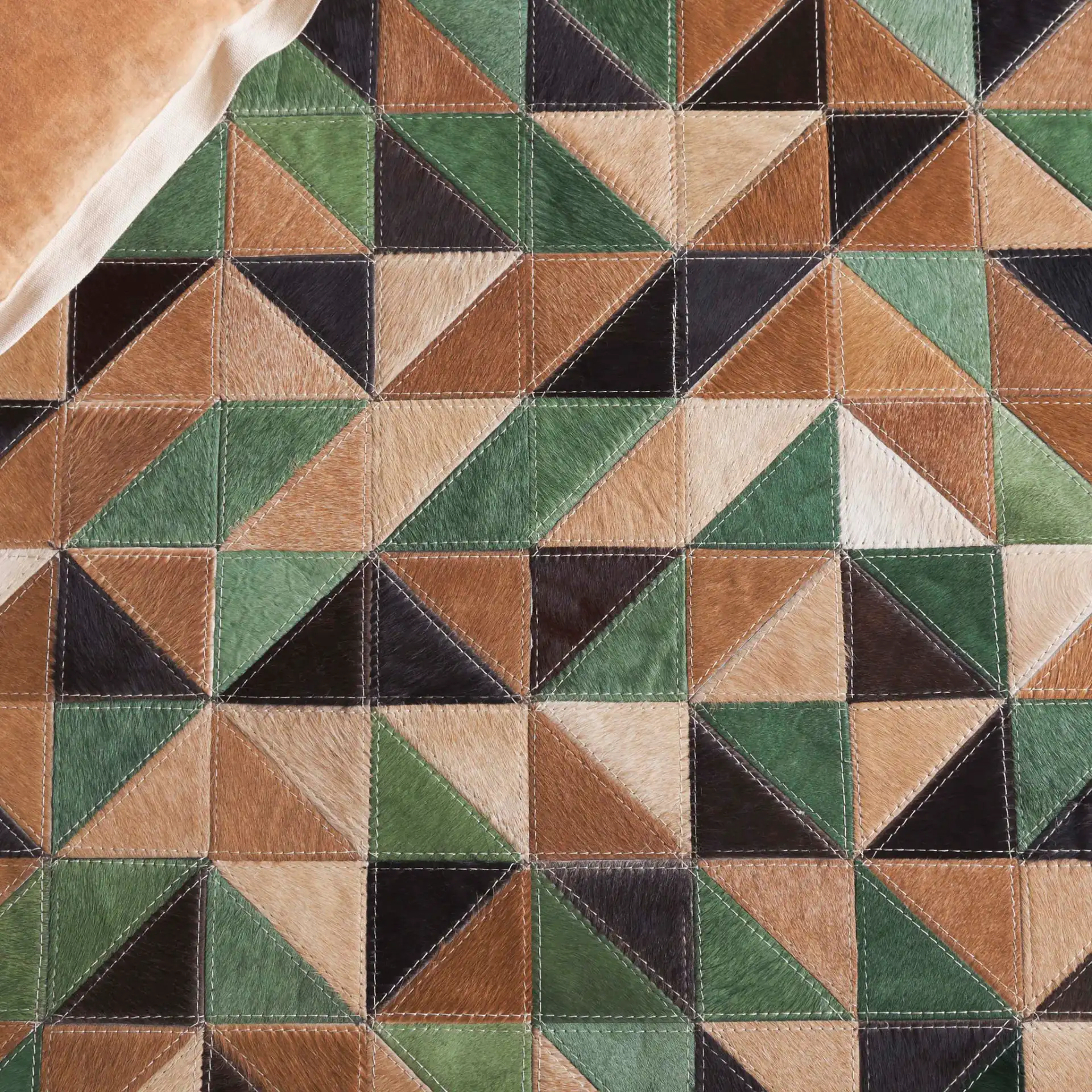 Studio Leather Modern Patchwork Geometric Hand-Woven Rug in Green / Light Brown in a styled room