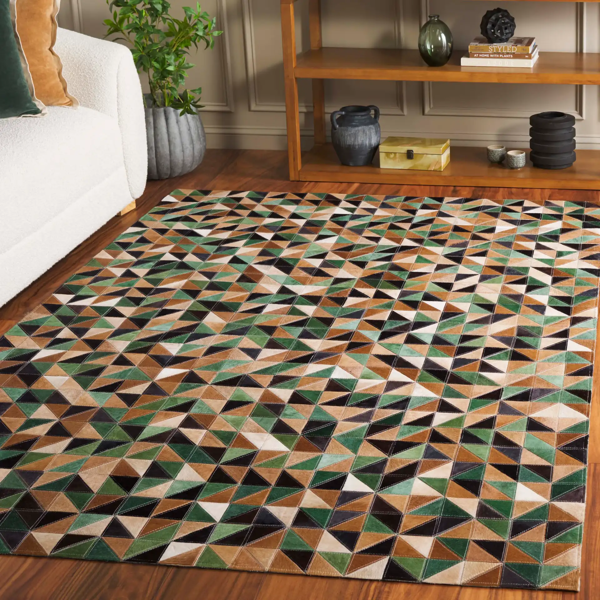 Studio Leather Modern Patchwork Geometric Hand-Woven Rug in Green / Light Brown in a styled room