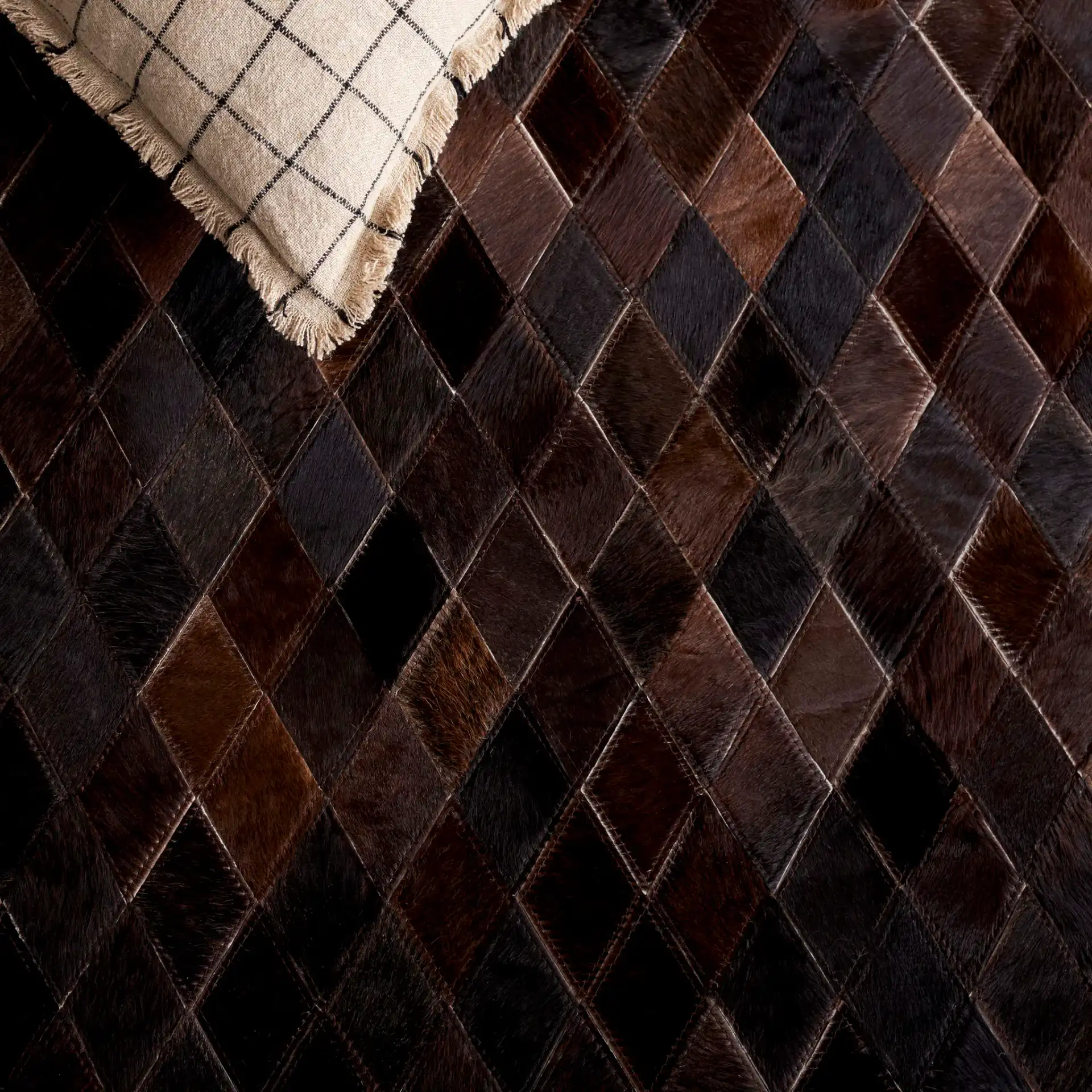 Studio Leather Harlequin Patchwork Hand-Woven Rug in Brown / Charcoal in a styled room