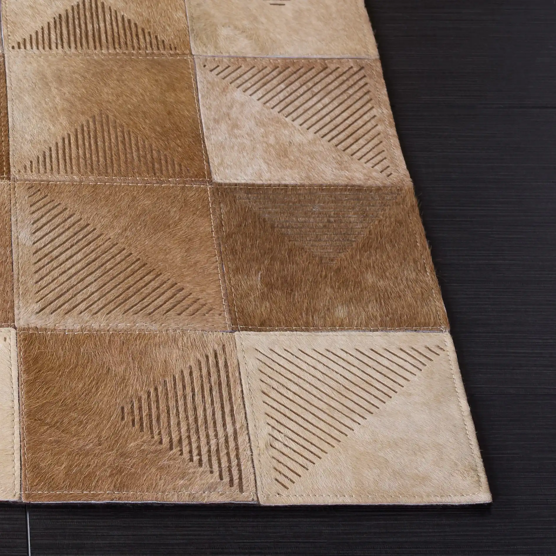 Studio Leather Geometric Patchwork Hand-Woven Rug in Beige / Brown in a styled room