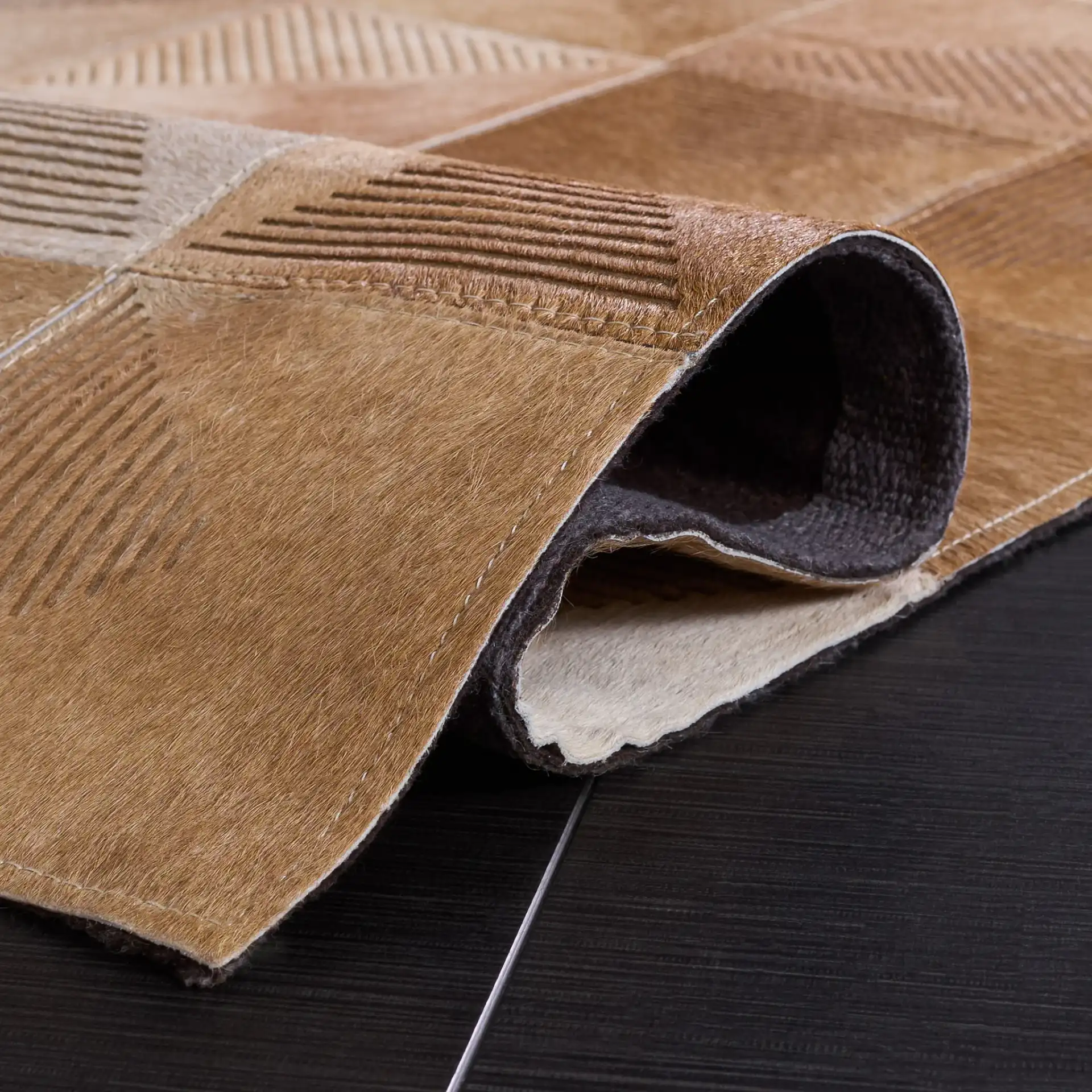 Studio Leather Geometric Patchwork Hand-Woven Rug in Beige / Brown in a styled room