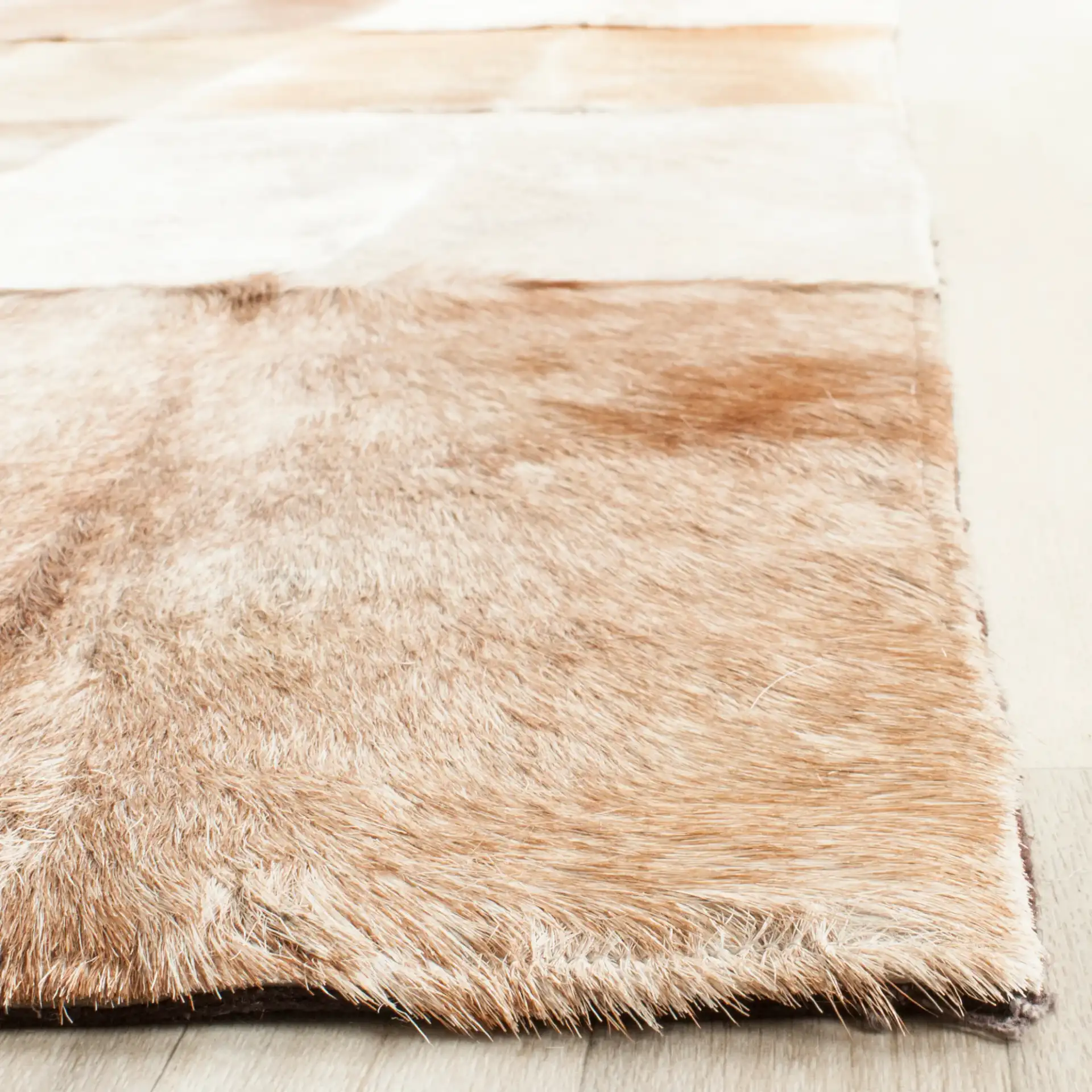 Studio Leather Patchwork Geometric Hand-Woven Rug in Beige / Brown in a styled room