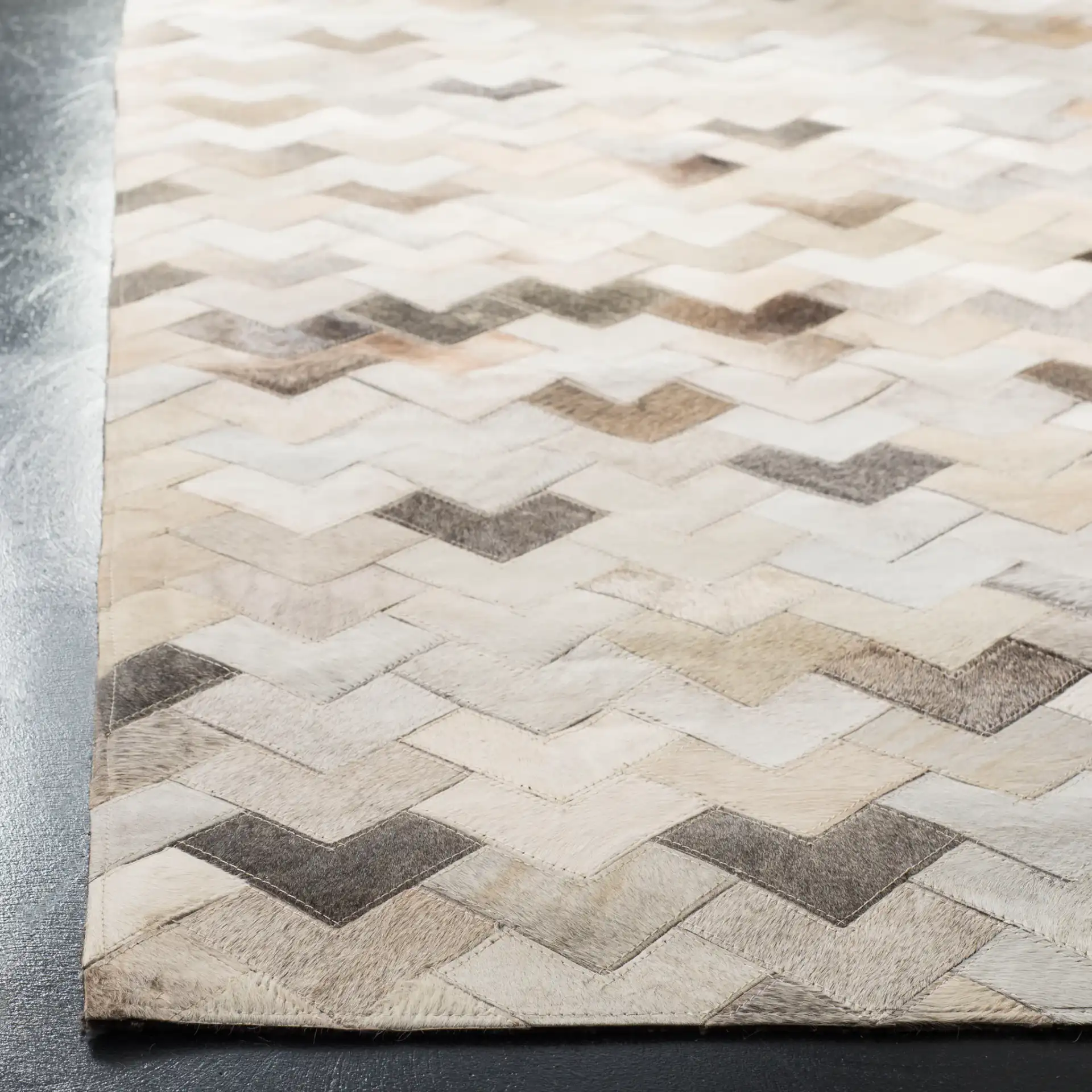 Studio Leather Chevron Patchwork Hand-Woven Rug in Gray in a styled room