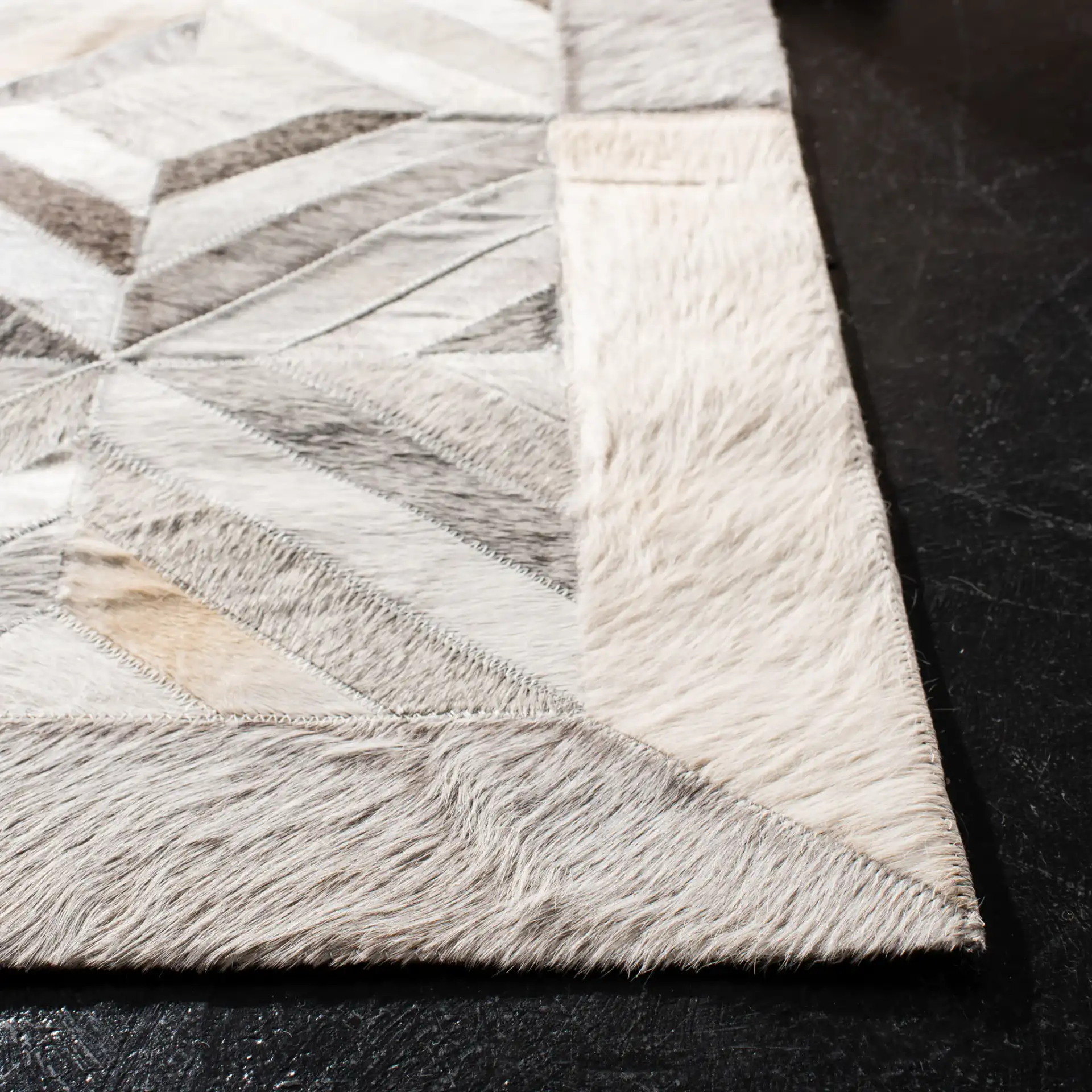 Studio Leather Patchwork Diamond Hand-Woven Rug in Gray in a styled room
