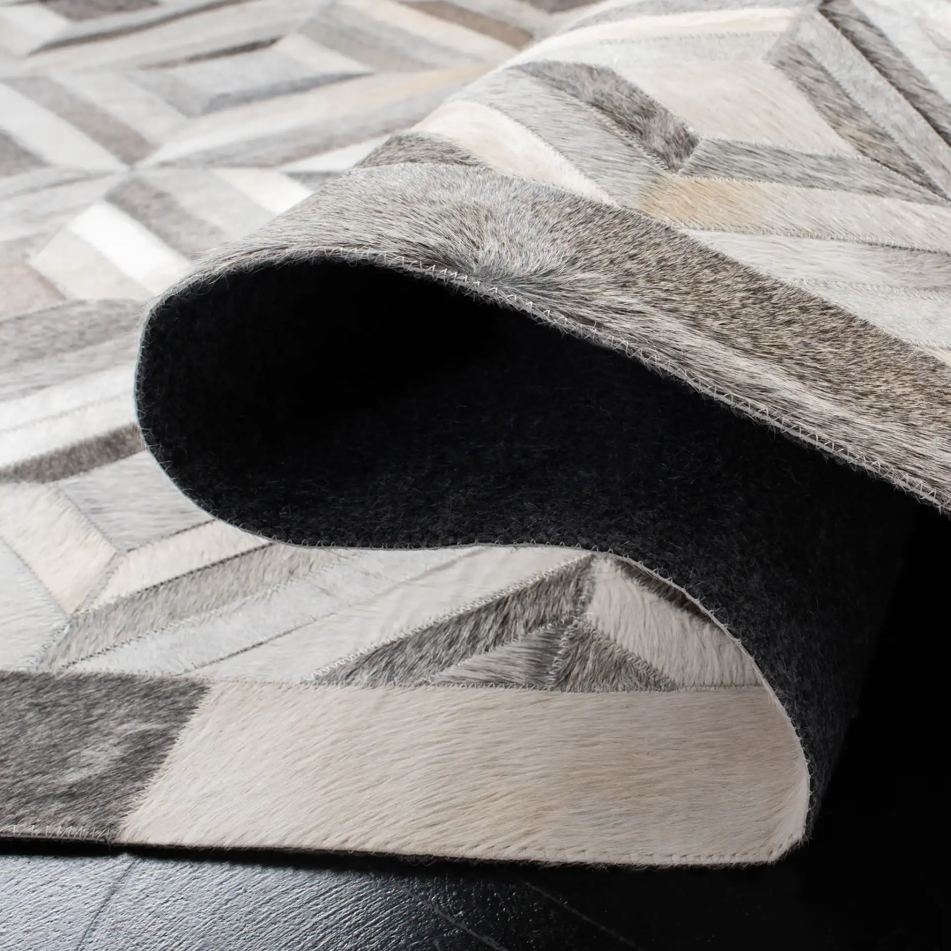 Studio Leather Patchwork Diamond Hand-Woven Rug in Gray in a styled room
