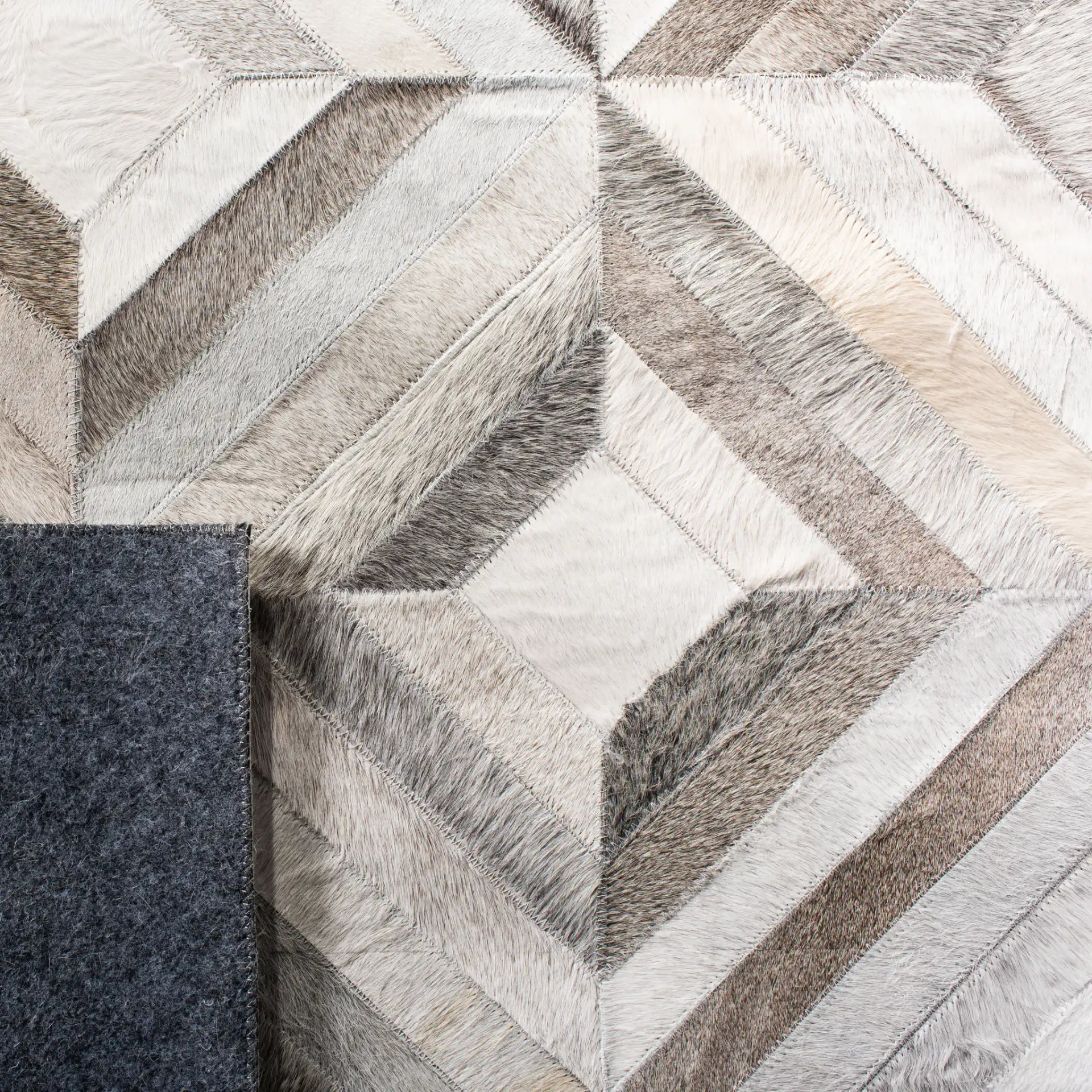 Studio Leather Patchwork Diamond Hand-Woven Rug in Gray in a styled room