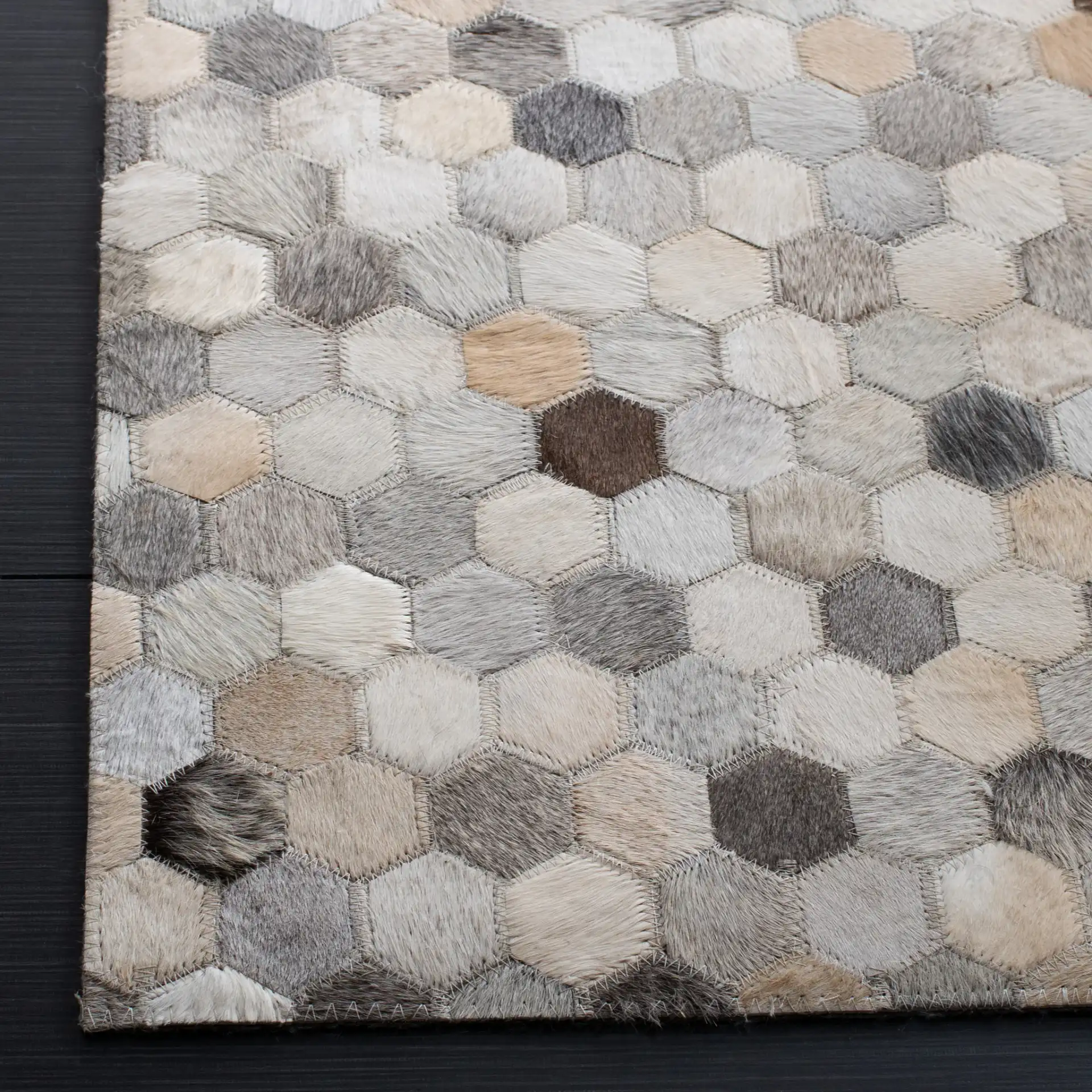 Studio Leather Honeycomb Patchwork Hand-Woven Rug in Ivory / Gray in a styled room