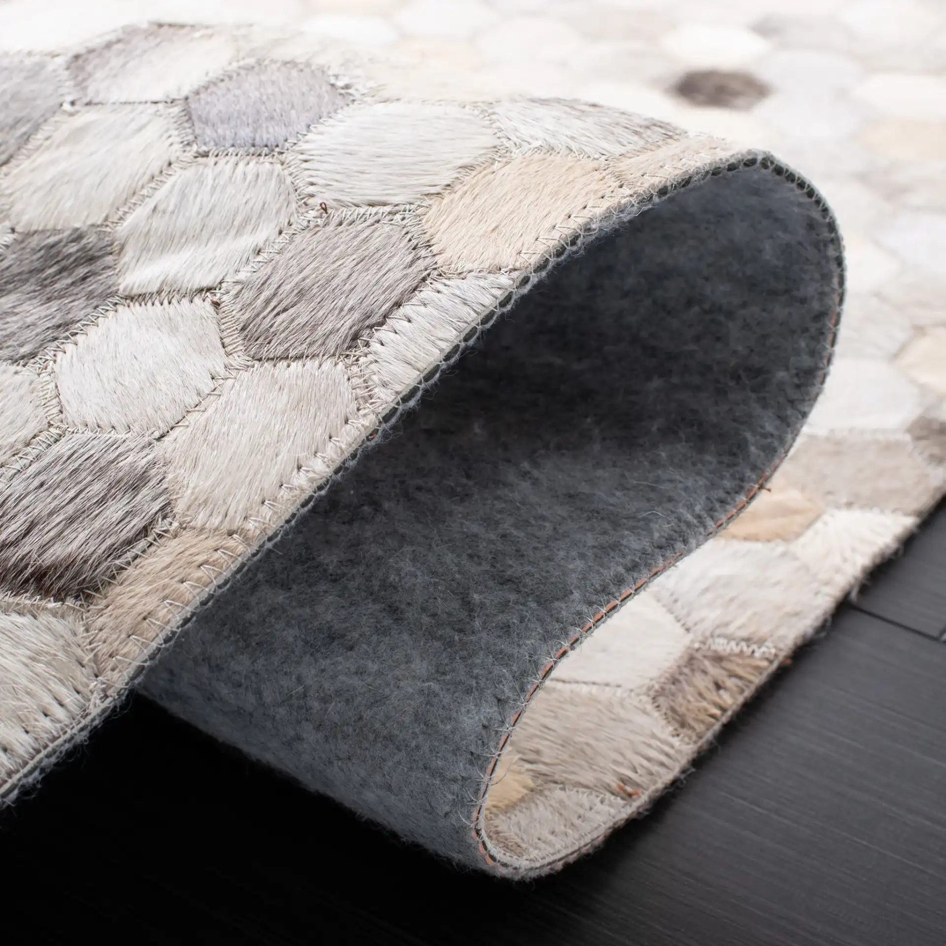 Studio Leather Honeycomb Patchwork Hand-Woven Rug in Ivory / Gray in a styled room