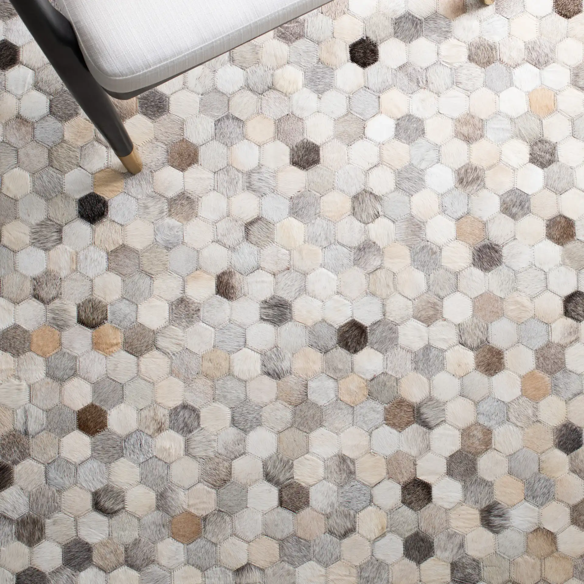 Studio Leather Honeycomb Patchwork Hand-Woven Rug in Ivory / Gray in a styled room