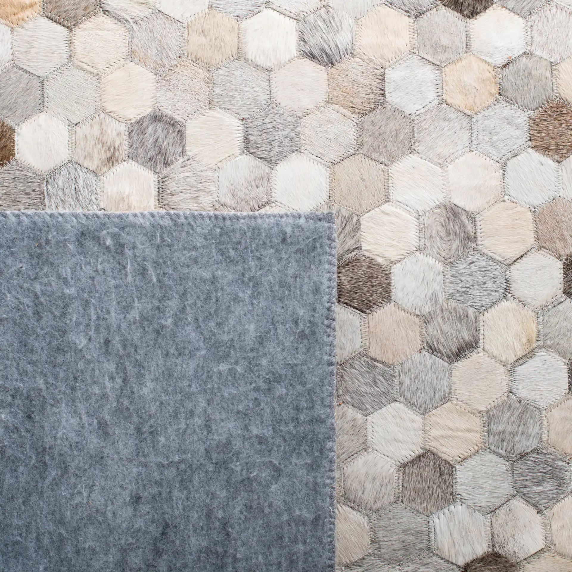 Studio Leather Honeycomb Patchwork Hand-Woven Rug in Ivory / Gray in a styled room
