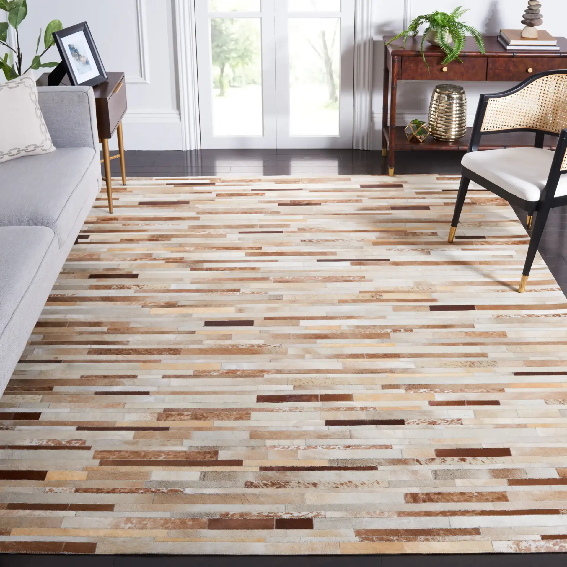 Studio Leather Patchwork Hand-Woven Rug in Tan / Ivory in a styled room