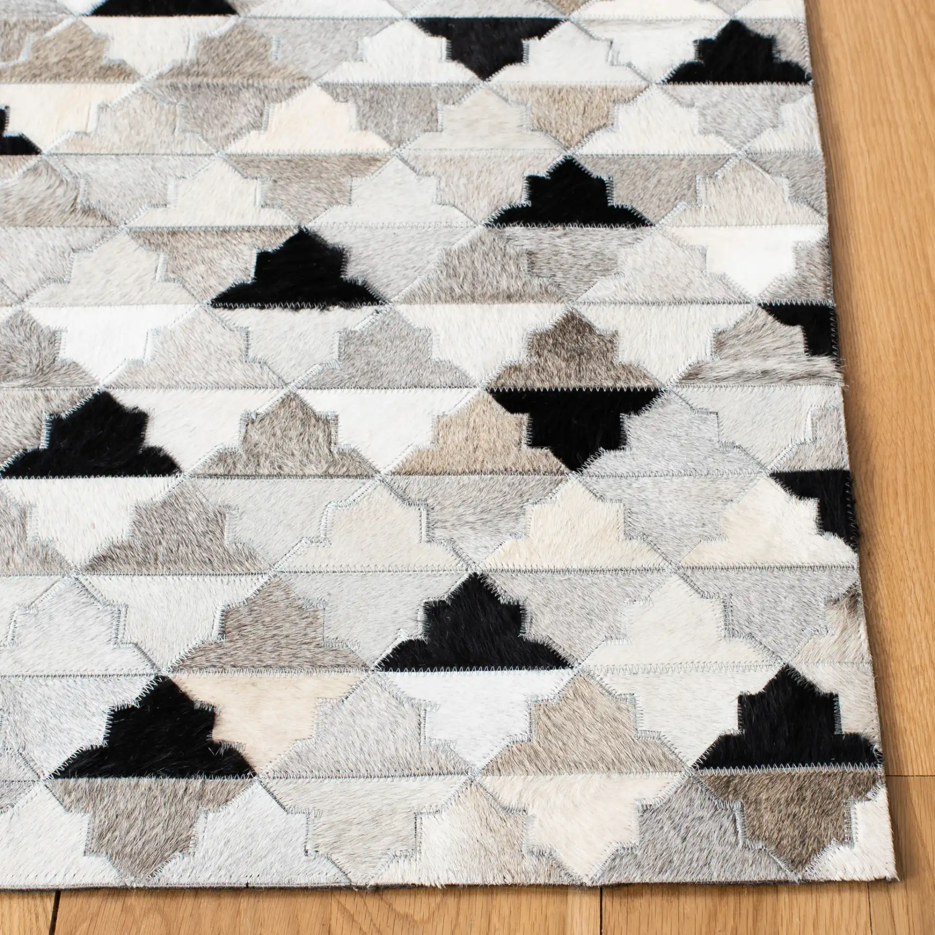 Studio Leather Stepped Triangle Flatweave Rug in Gray / Black in a styled room