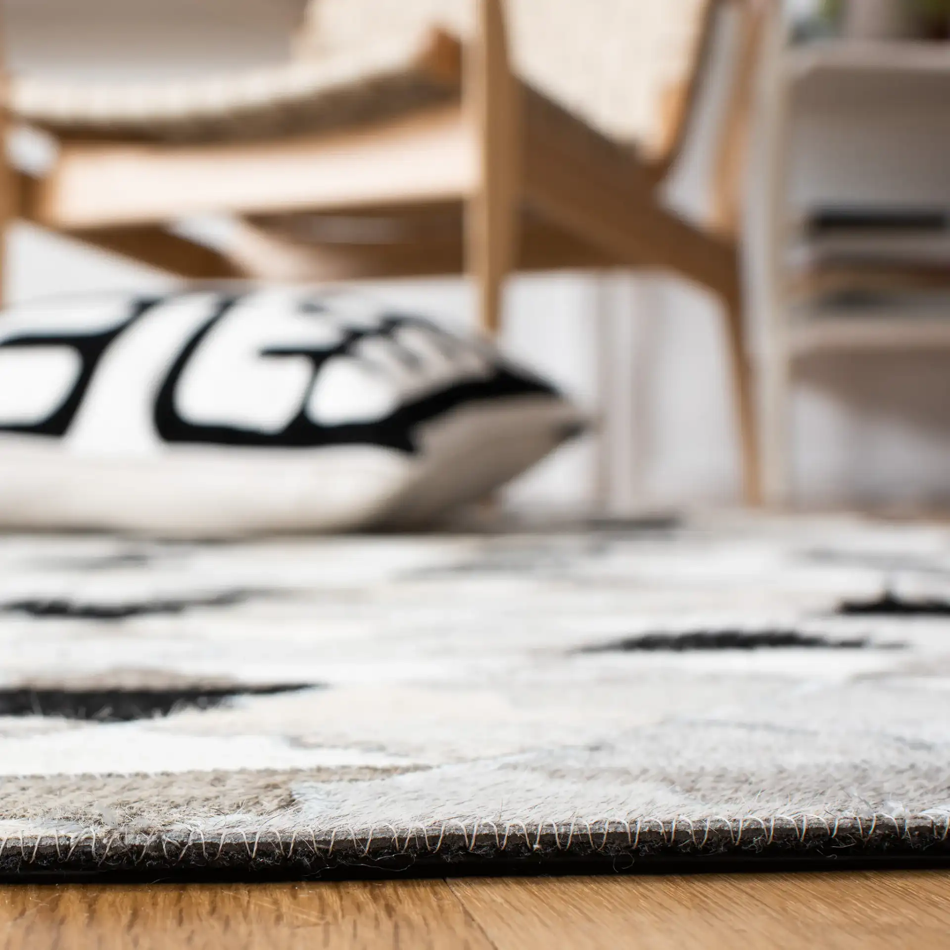 Studio Leather Stepped Triangle Flatweave Rug in Gray / Black in a styled room
