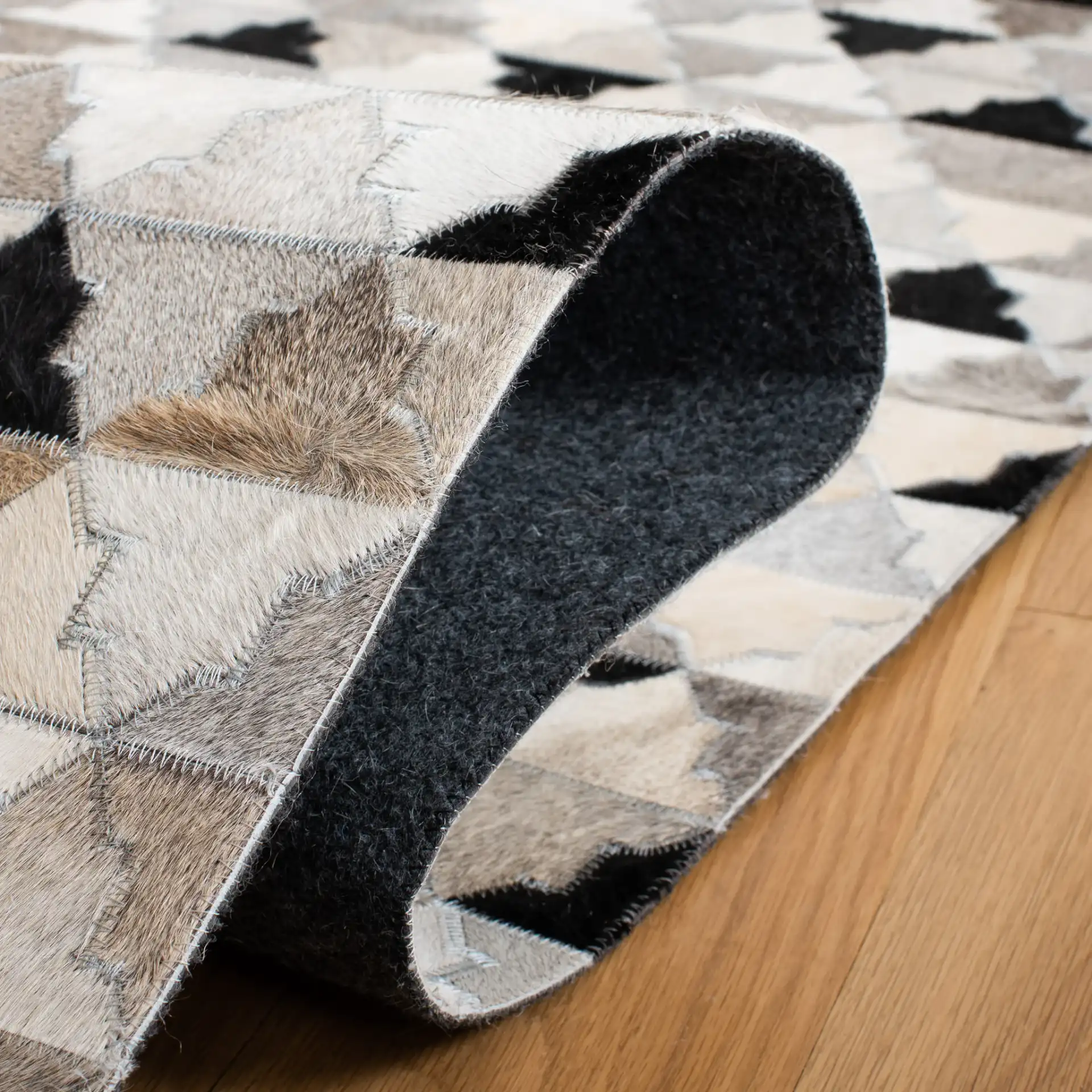 Studio Leather Stepped Triangle Flatweave Rug in Gray / Black in a styled room
