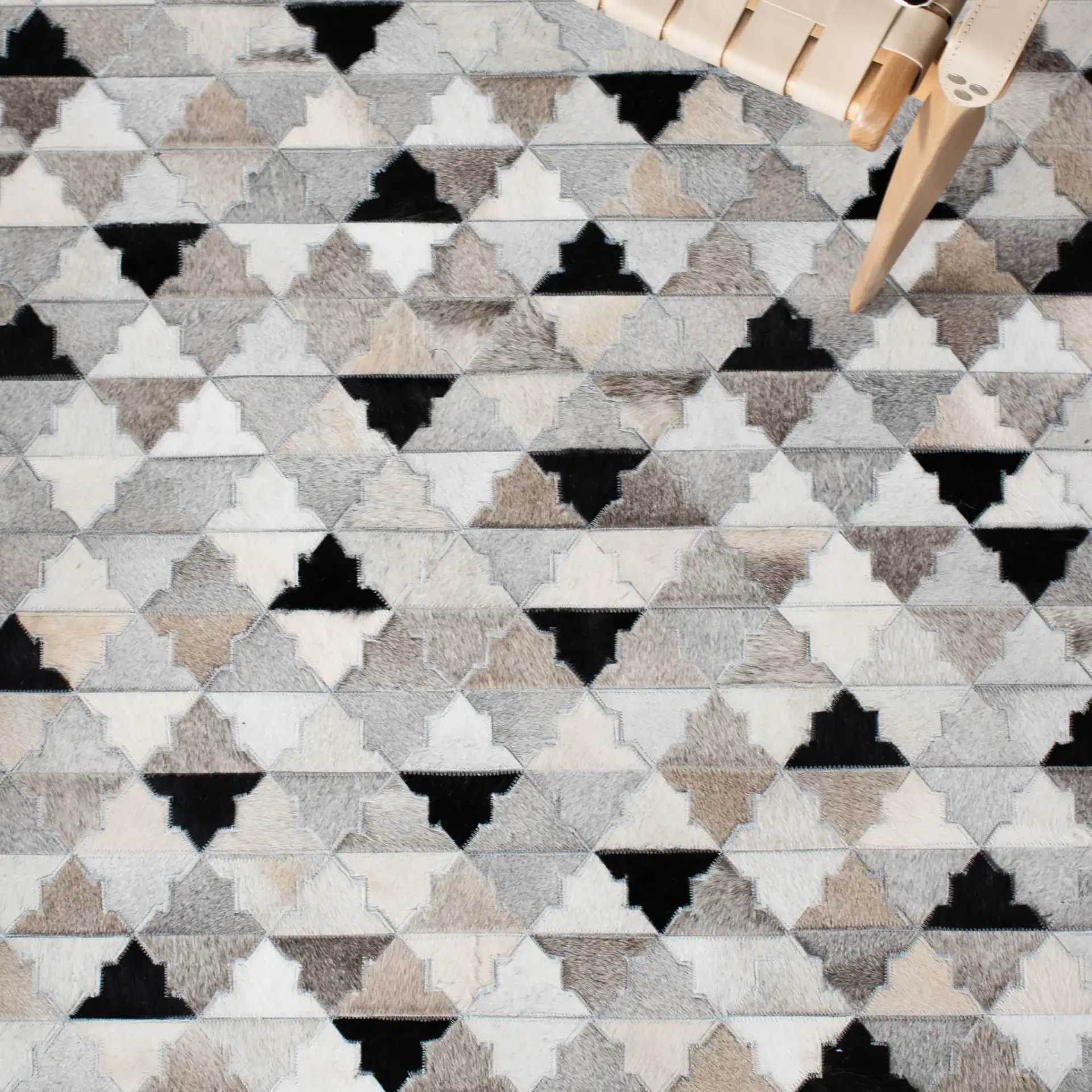 Studio Leather Stepped Triangle Flatweave Rug in Gray / Black in a styled room