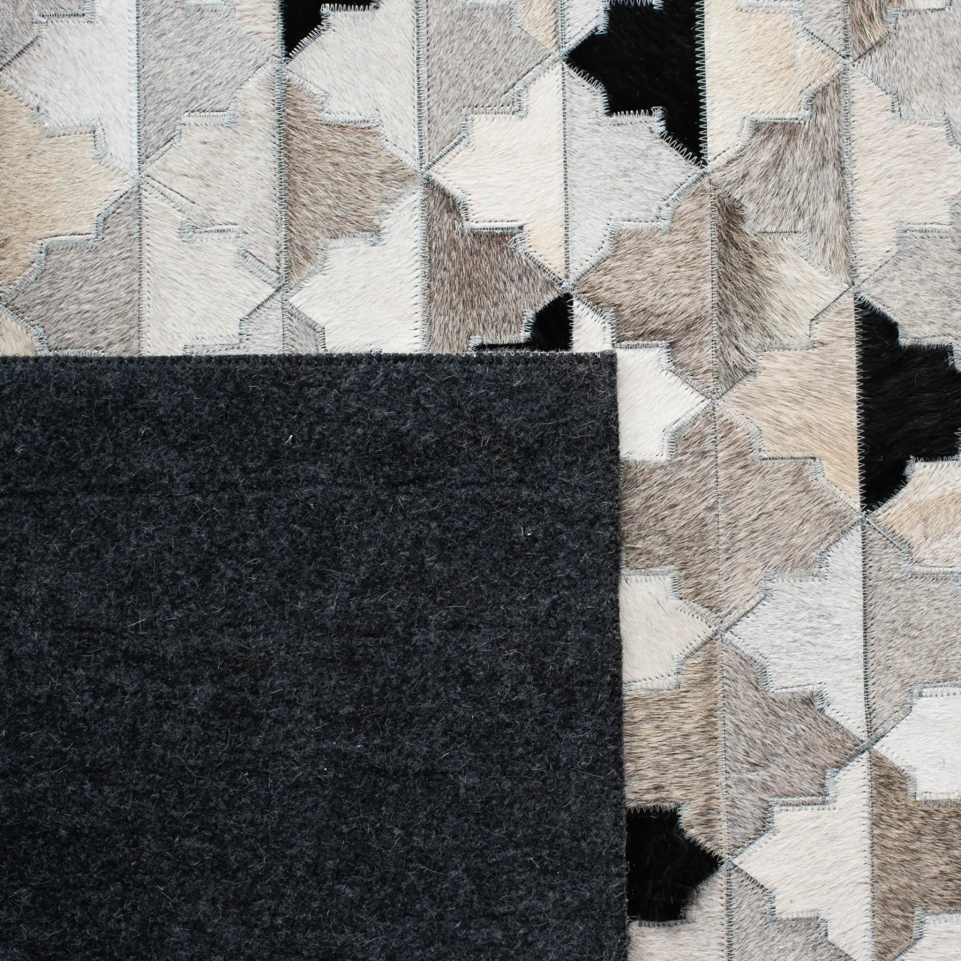 Studio Leather Stepped Triangle Flatweave Rug in Gray / Black in a styled room