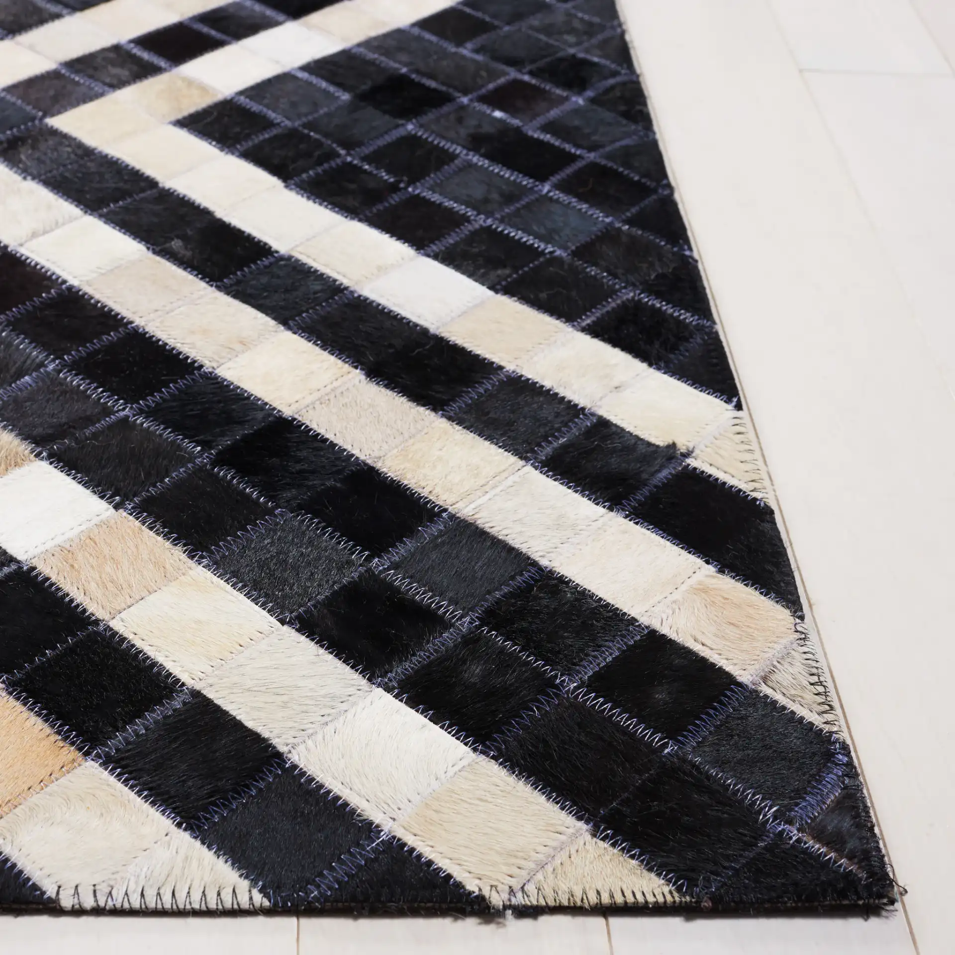 Studio Leather Labyrinth Flatweave Rug in Black / Ivory in a styled room