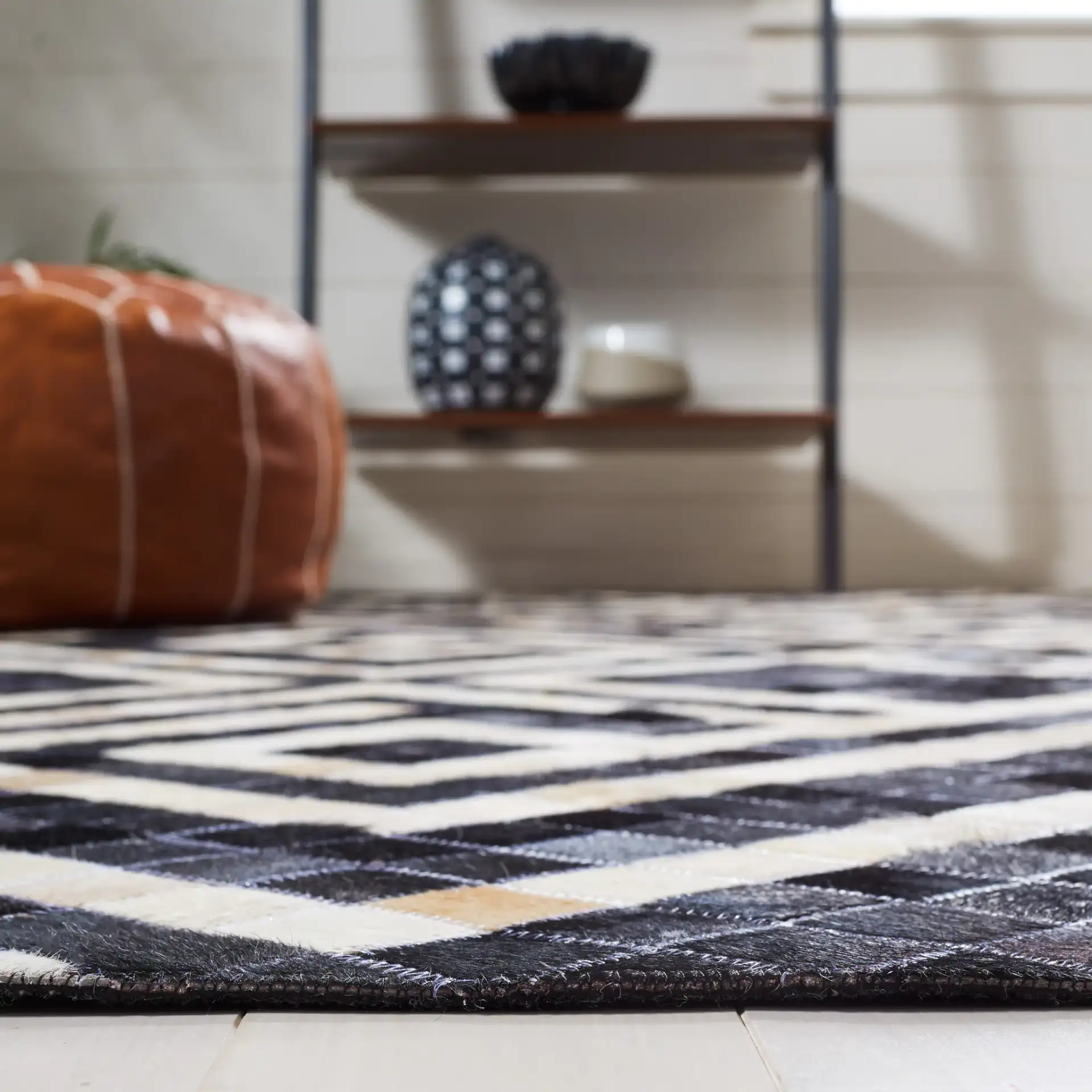 Studio Leather Labyrinth Flatweave Rug in Black / Ivory in a styled room