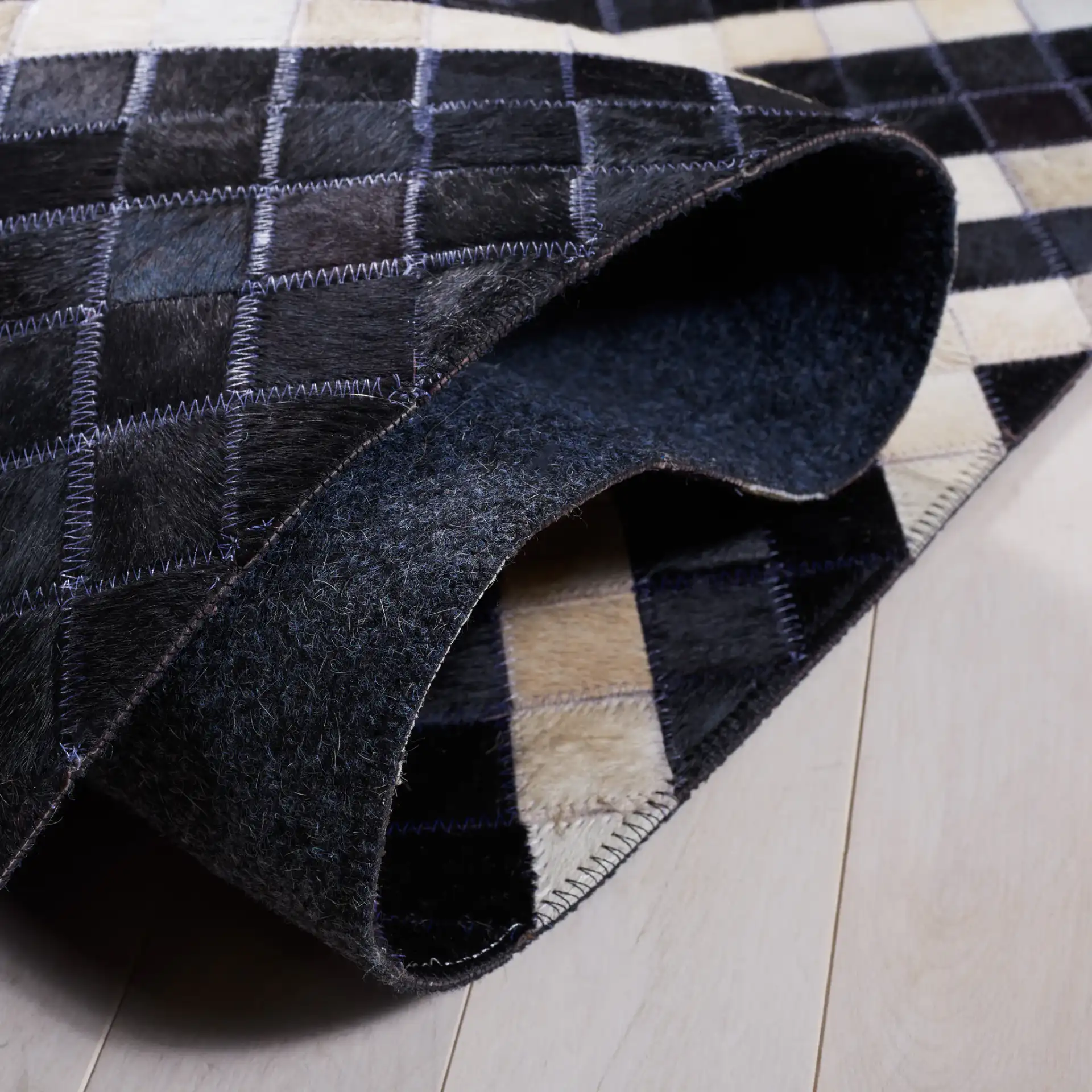 Studio Leather Labyrinth Flatweave Rug in Black / Ivory in a styled room