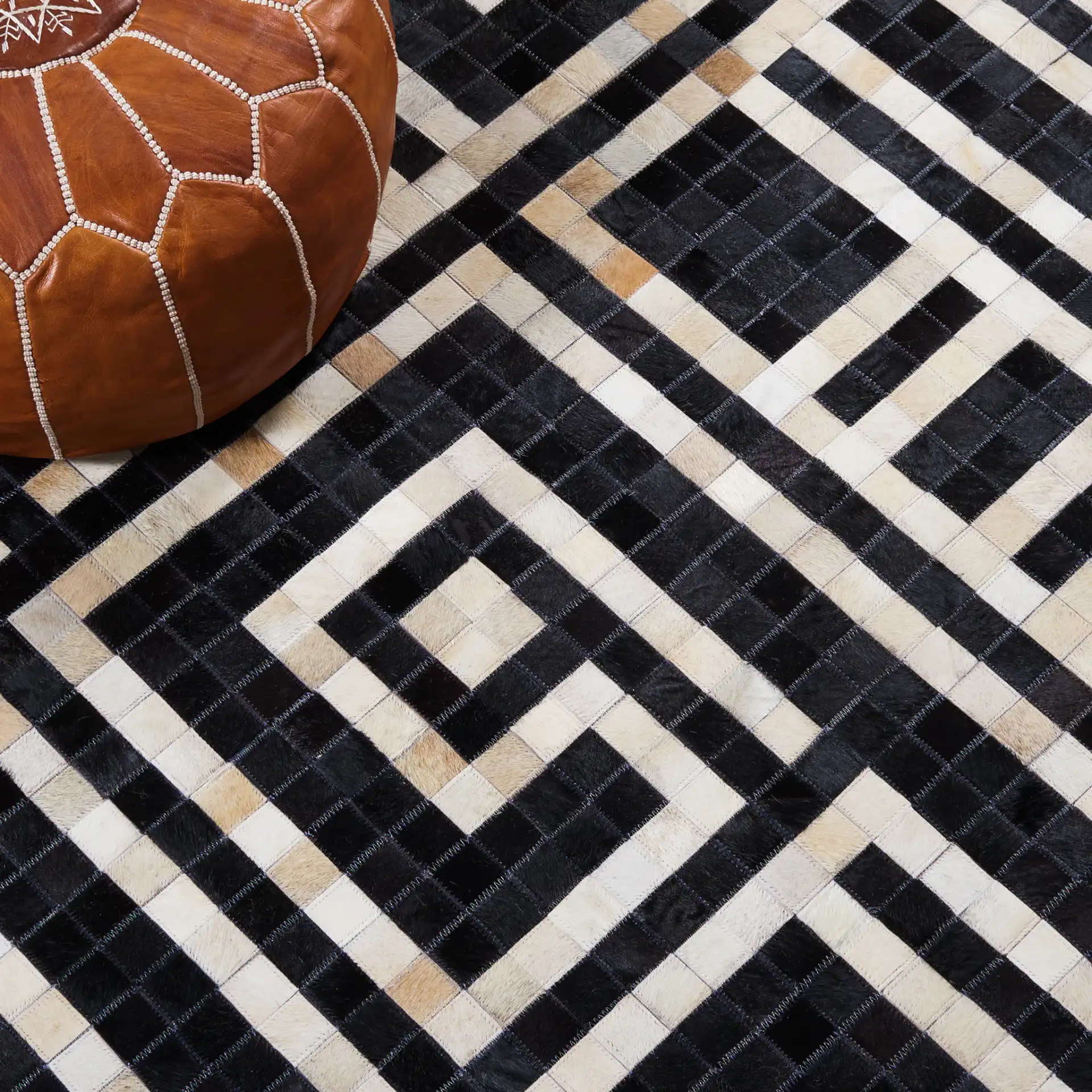 Studio Leather Labyrinth Flatweave Rug in Black / Ivory in a styled room