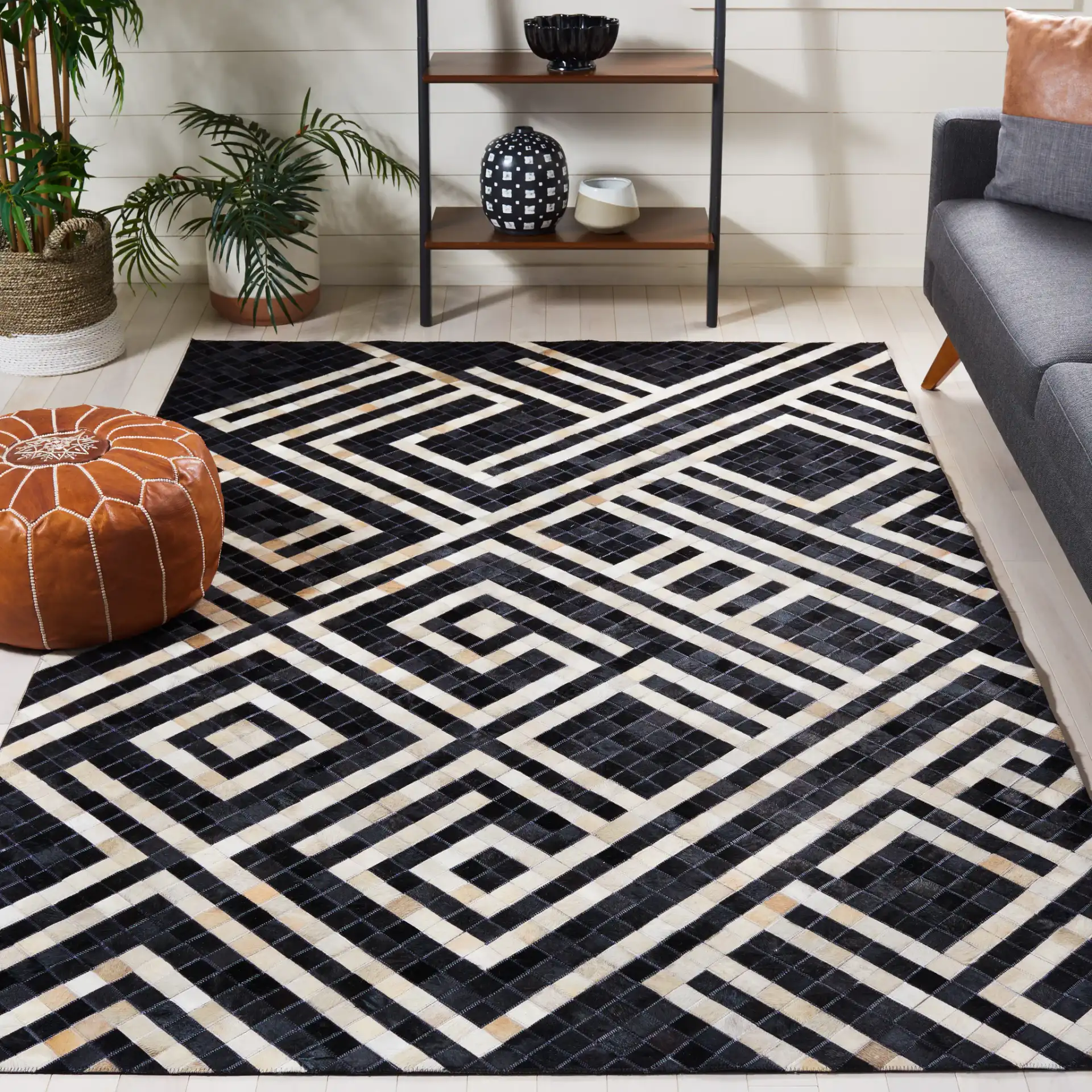 Studio Leather Labyrinth Flatweave Rug in Black / Ivory in a styled room