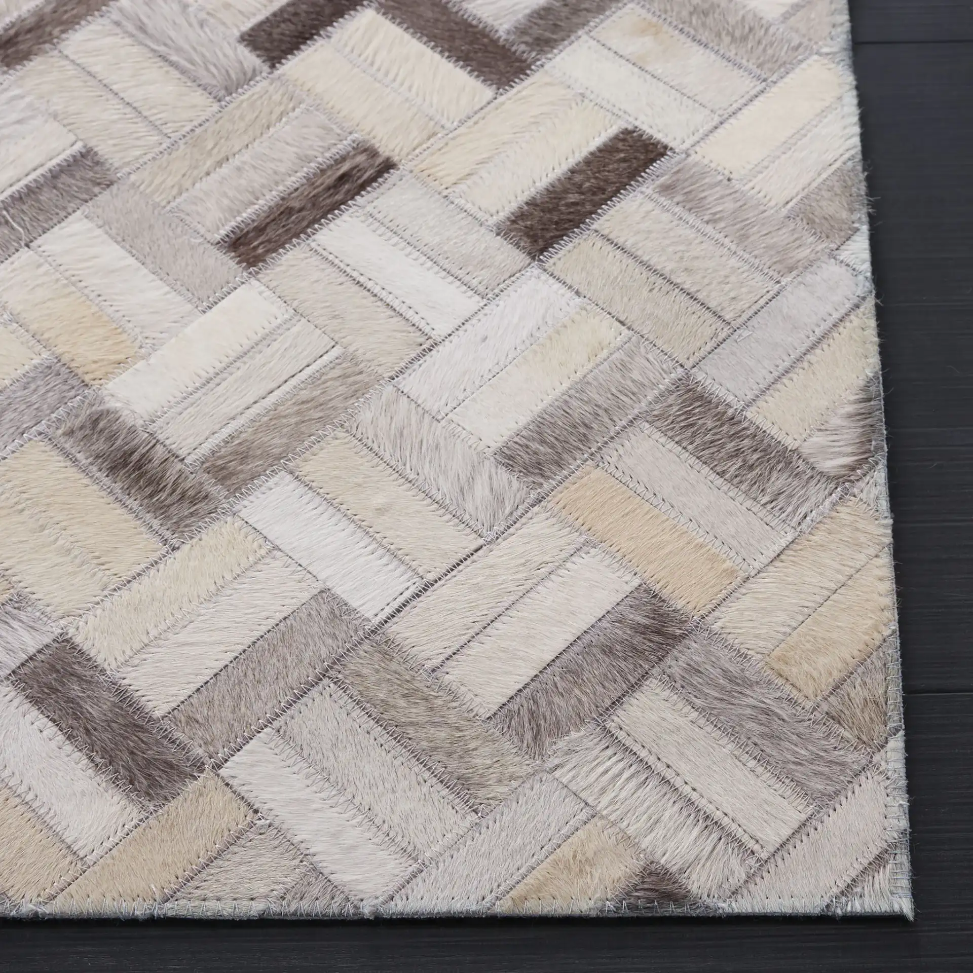 Studio Leather Modern Herringbone Rug in Black / Gray in a styled room