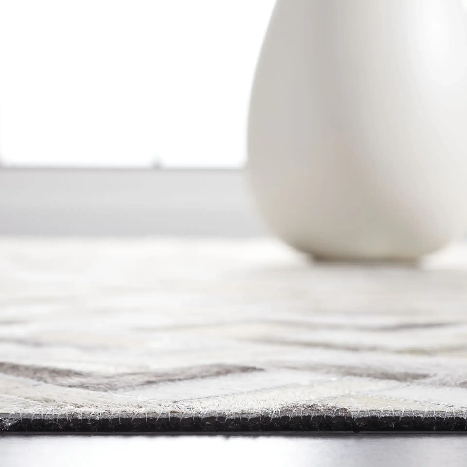 Studio Leather Modern Herringbone Rug in Black / Gray in a styled room