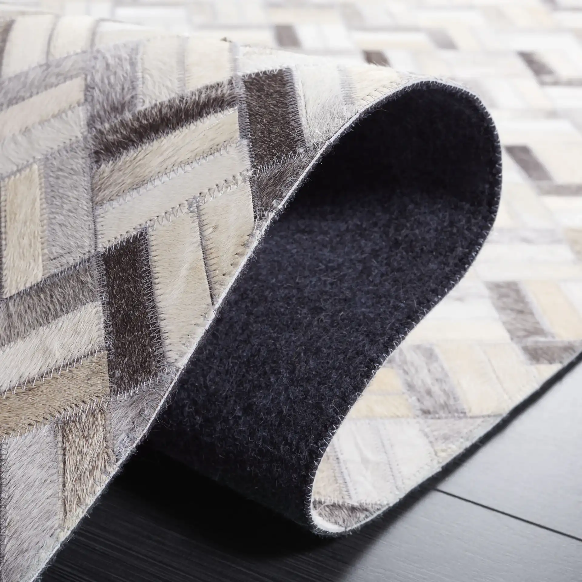 Studio Leather Modern Herringbone Rug in Black / Gray in a styled room