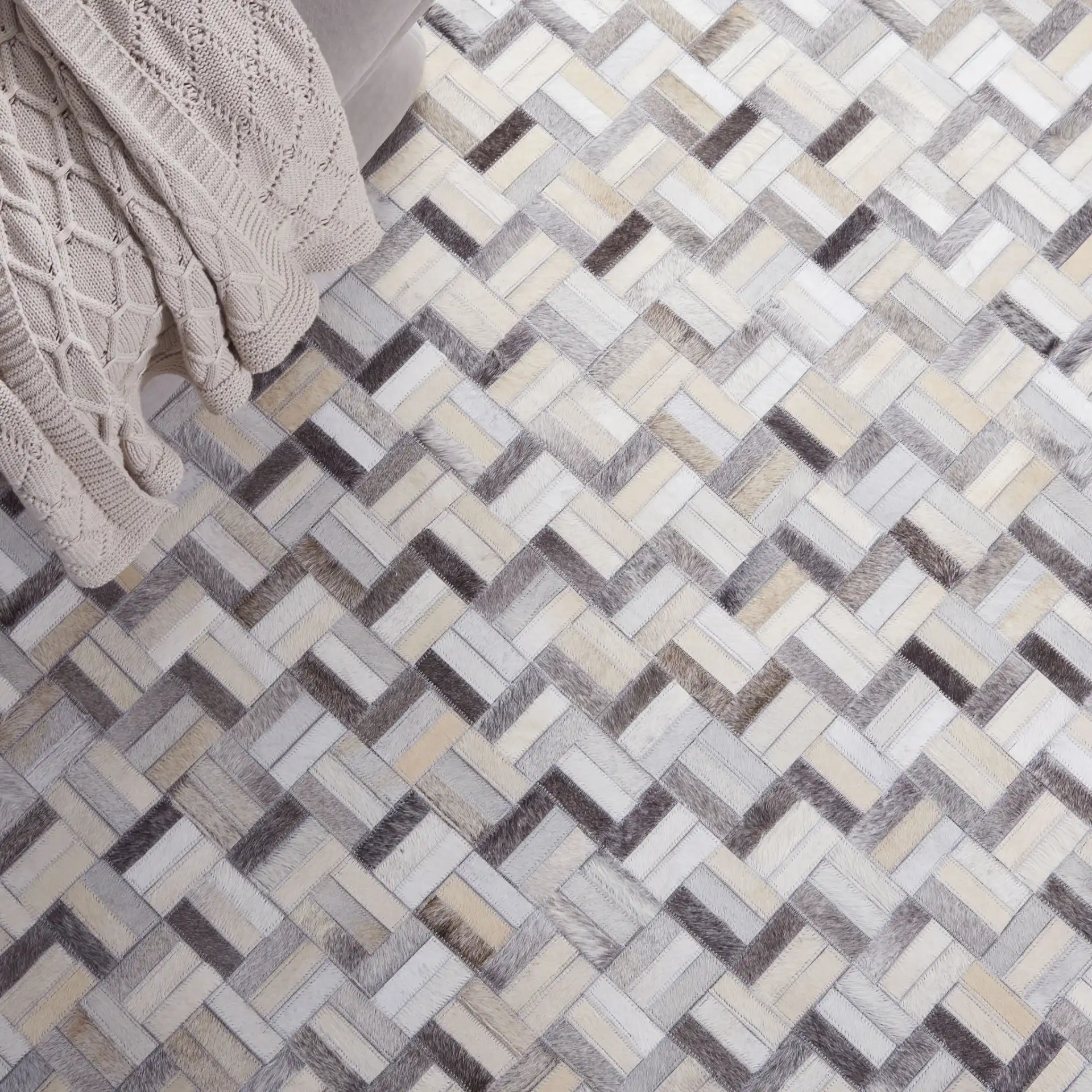 Studio Leather Modern Herringbone Rug in Black / Gray in a styled room