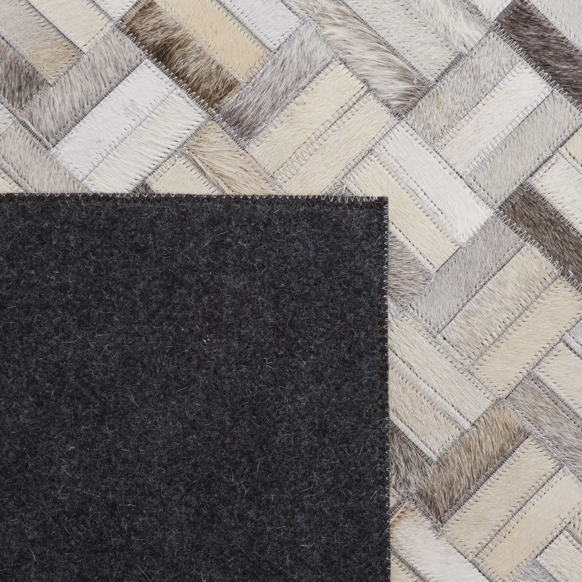 Studio Leather Modern Herringbone Rug in Black / Gray in a styled room