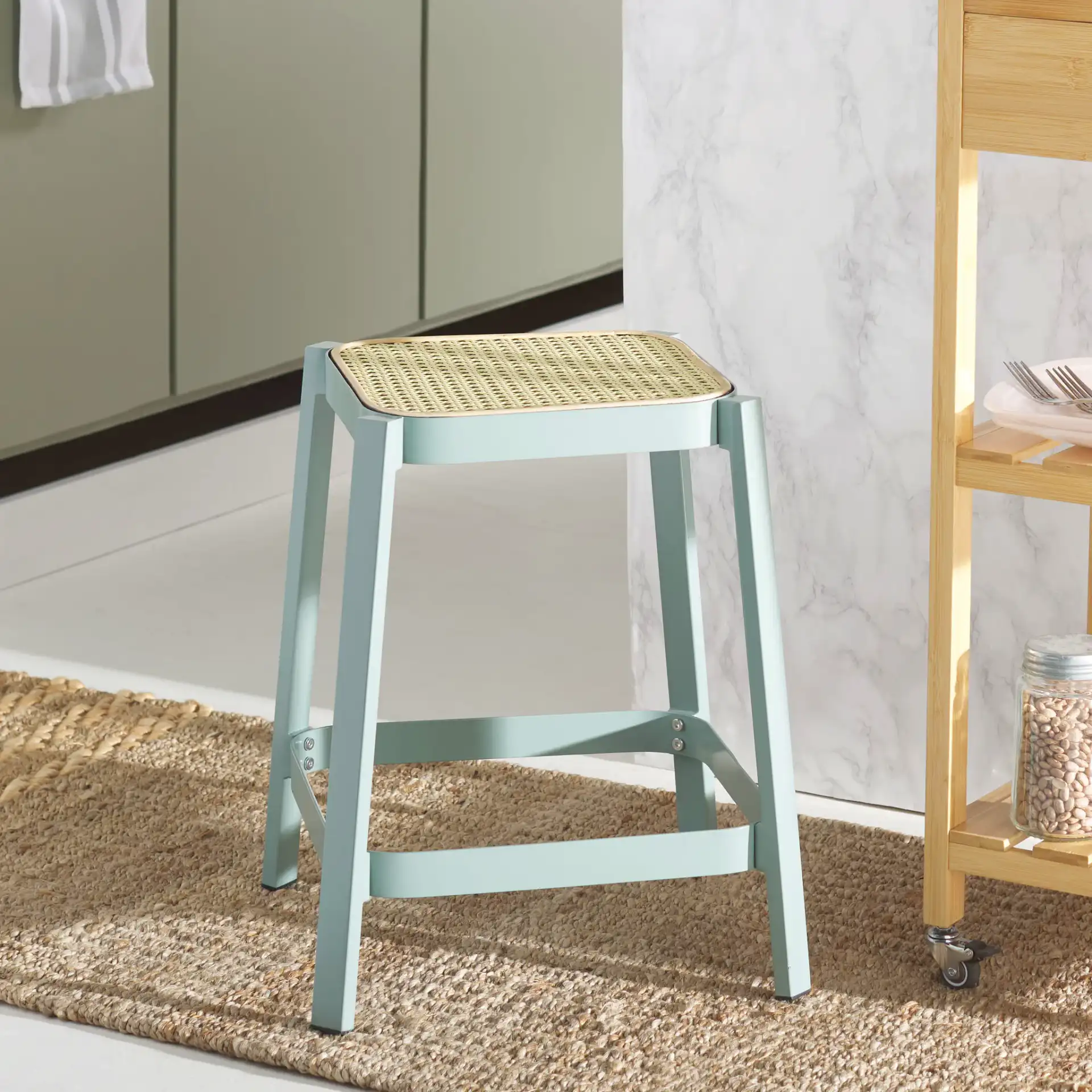 Palmyra Cane Stool in Aqua Smoke / Natural in a styled room