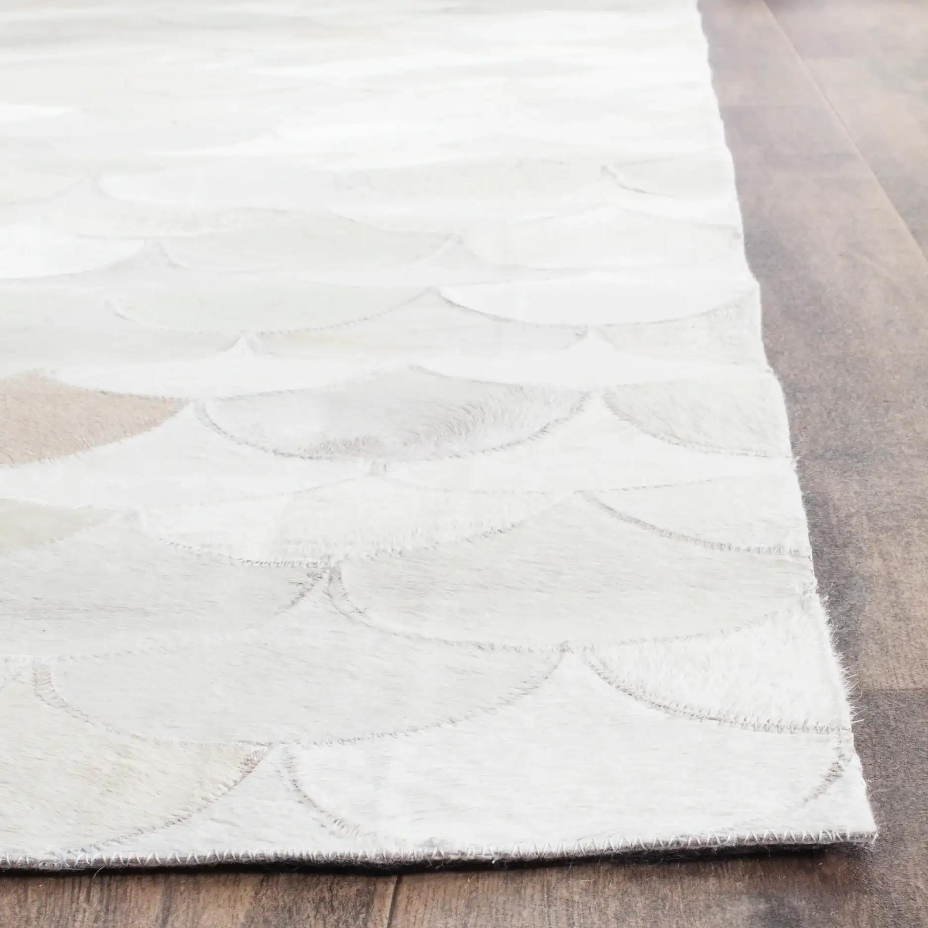 Studio Leather Fish Scale Patchwork Hand-Woven Rug in Ivory / Gray in a styled room